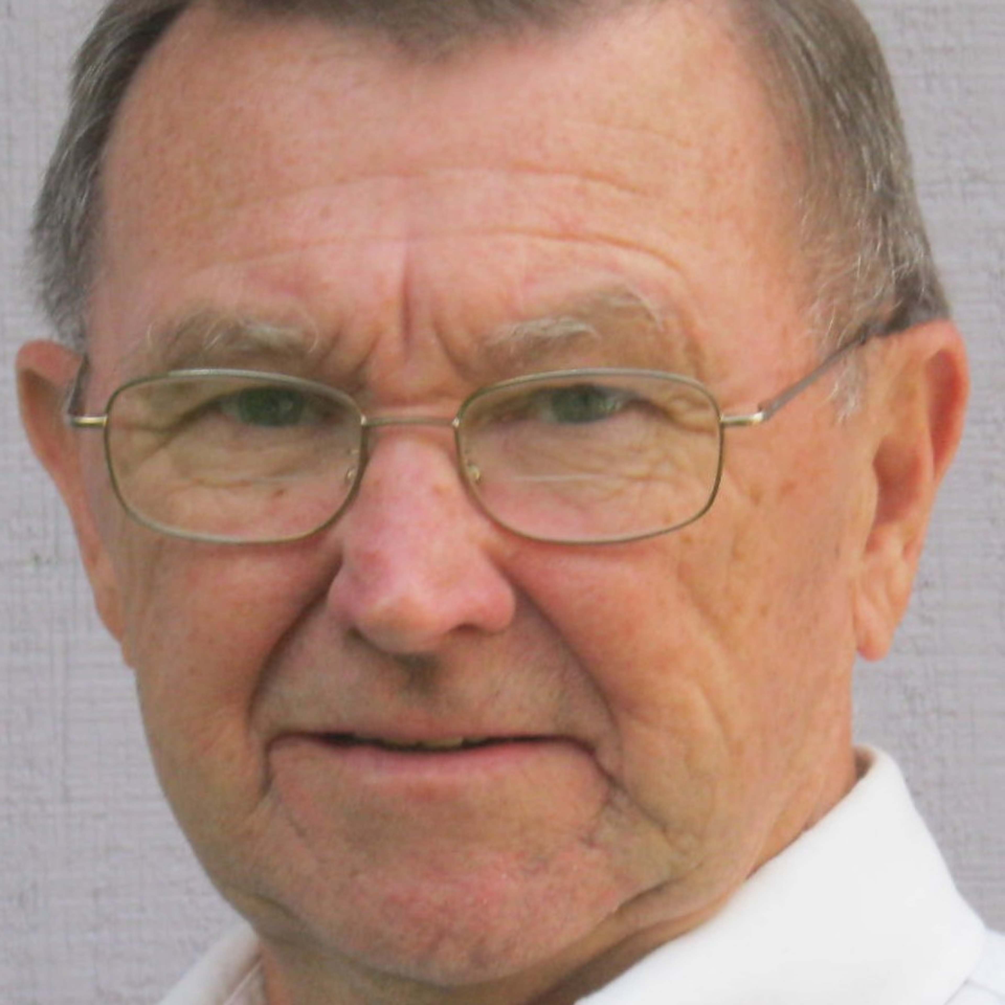 head shot of writer Chuck Lyons with glasses and a white collared shirt