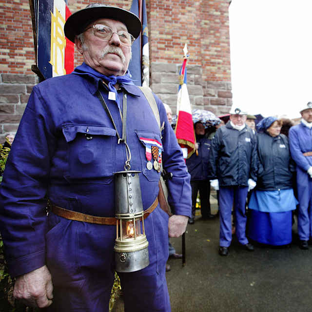 Former miners attend a ceremony marking