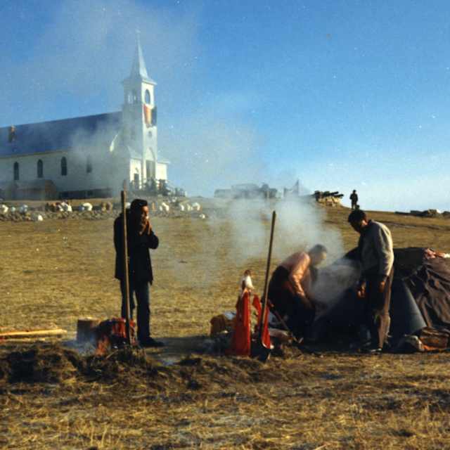 View of several members of the American Indian Movement (AIM) as they stand next to a sweat lodge erected on a hill below the Sacred Heart Church during the occupation of the town of Wounded Knee on the Pine Ridge Reservation, South Dakota, 1973. AIM occupied the town, exchanging gunfire with local and federal troops, from February 27 through May 8, 1973, following internal reservation disputes as well as disatisfaction with the US government's treatment of Native American peoples in general. (Photo by Peter Davis/Getty Images)