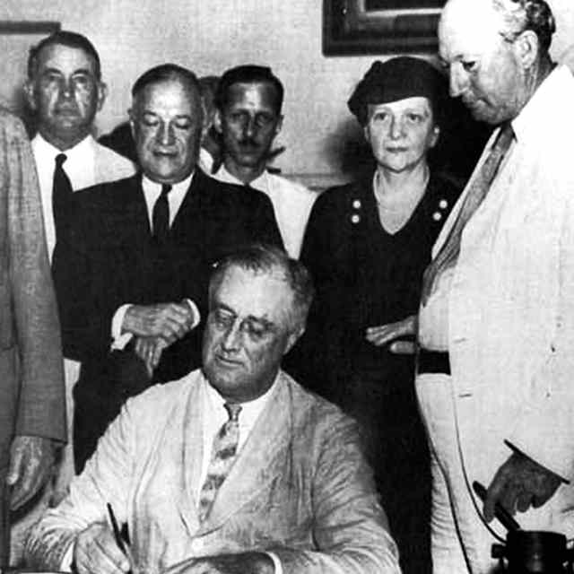 Franklin D. Roosevelt. United States President Franklin D. Roosevelt signing the Social Security Bill (Act) in 1935. (Photo by: Photo12/Universal Images Group via Getty Images)