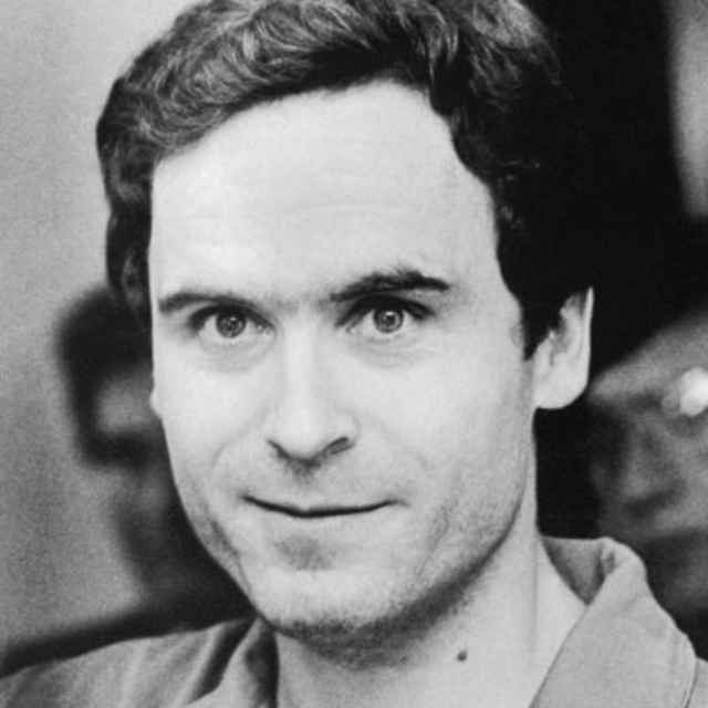 Serial Murderer Theodore "Ted" Bundy walks forward and waves to TV camera as his indictment for the January murders of Lisa Levy and Margaret Bowman is read at the Leon County Jail.