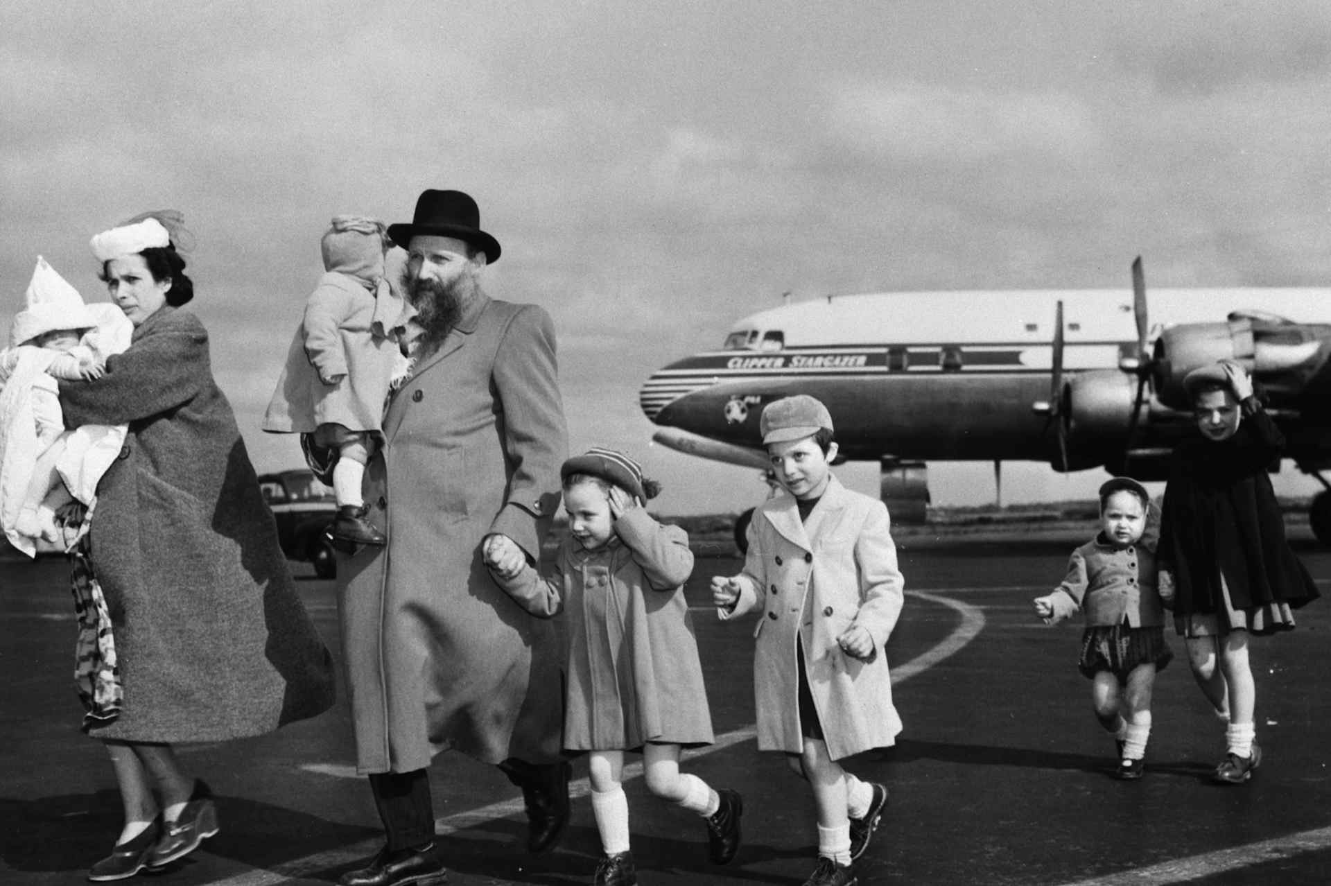 Chaim and Bina Gasthalter of Poland arrive at New York's Idylwild Airport with their six children for resettlement in Detroit. Gasthalter spent five years in Russian slave labor camps.