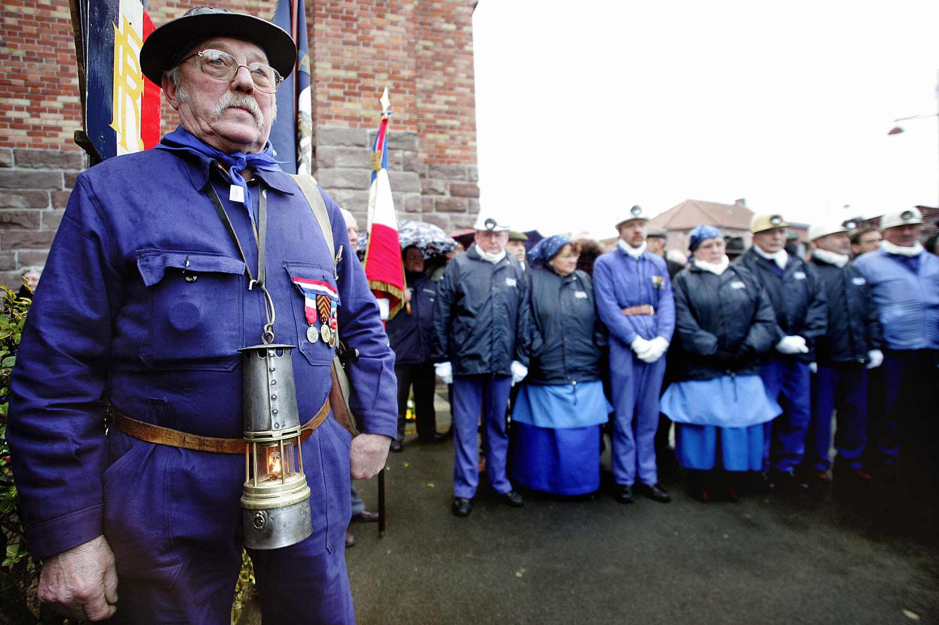Former miners attend a ceremony marking
