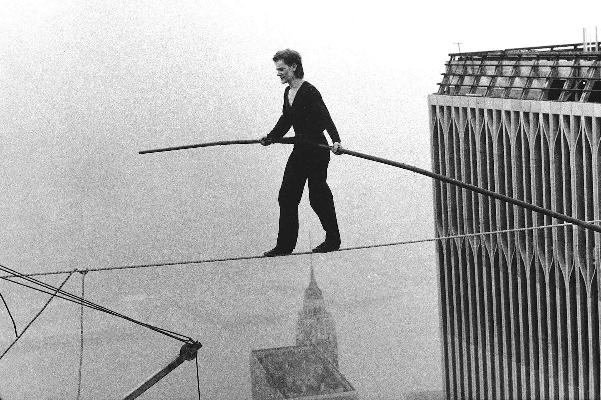 Philippe Petit crossing the Twin Towers on a tightrope.