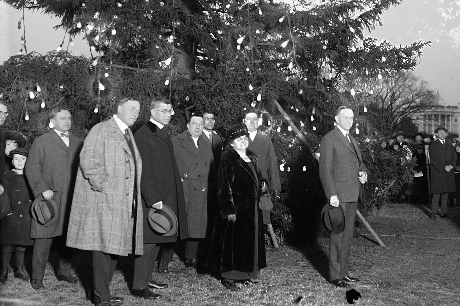President Coolidge lights the first national Christmas tree.