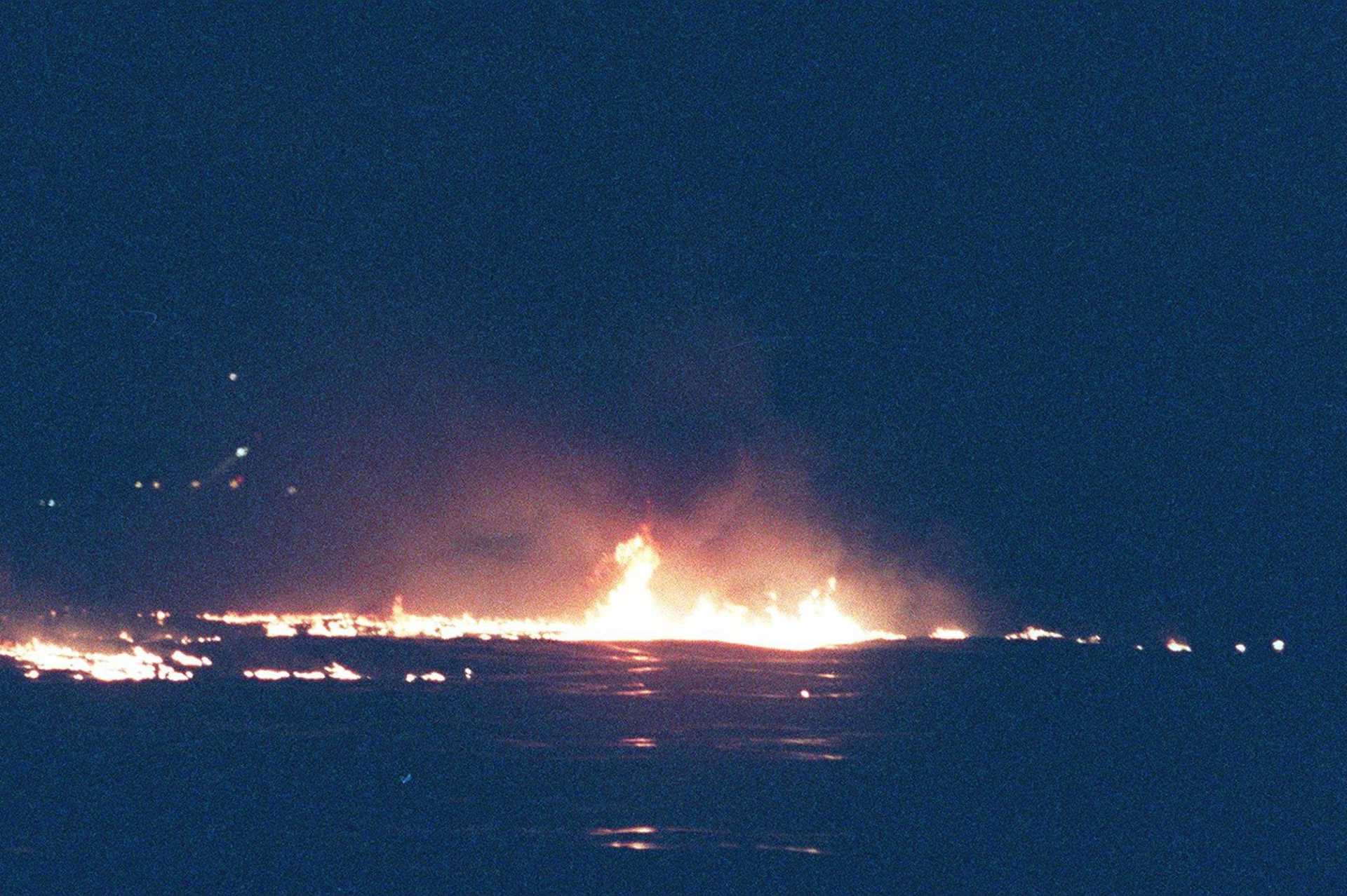 Flames from burning jet fuel on the waters off of Long Island from the TWA Flight 800 Boeing 747-100 aircraft that exploded on July 17, 1996 near East Moriches, New York.
