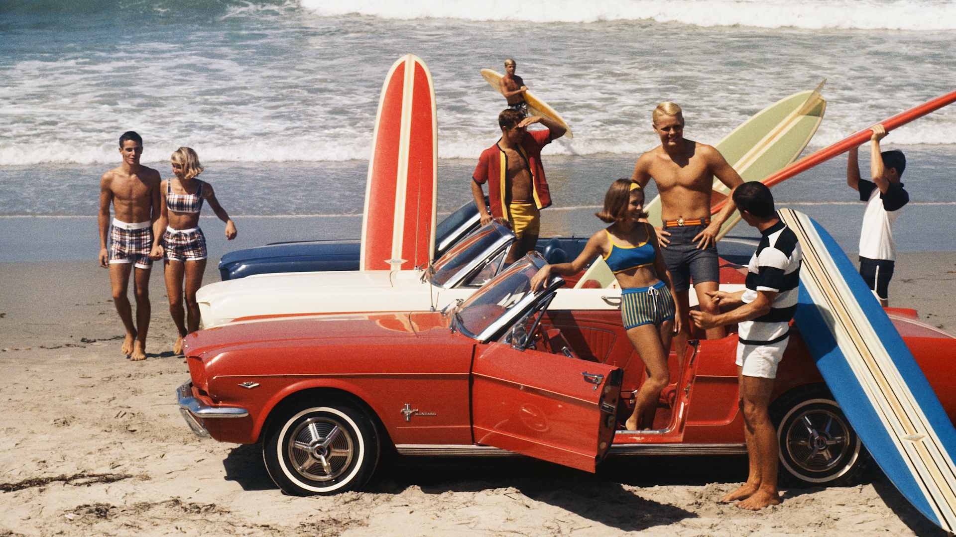 Friends having fun on beach, circa 1968.