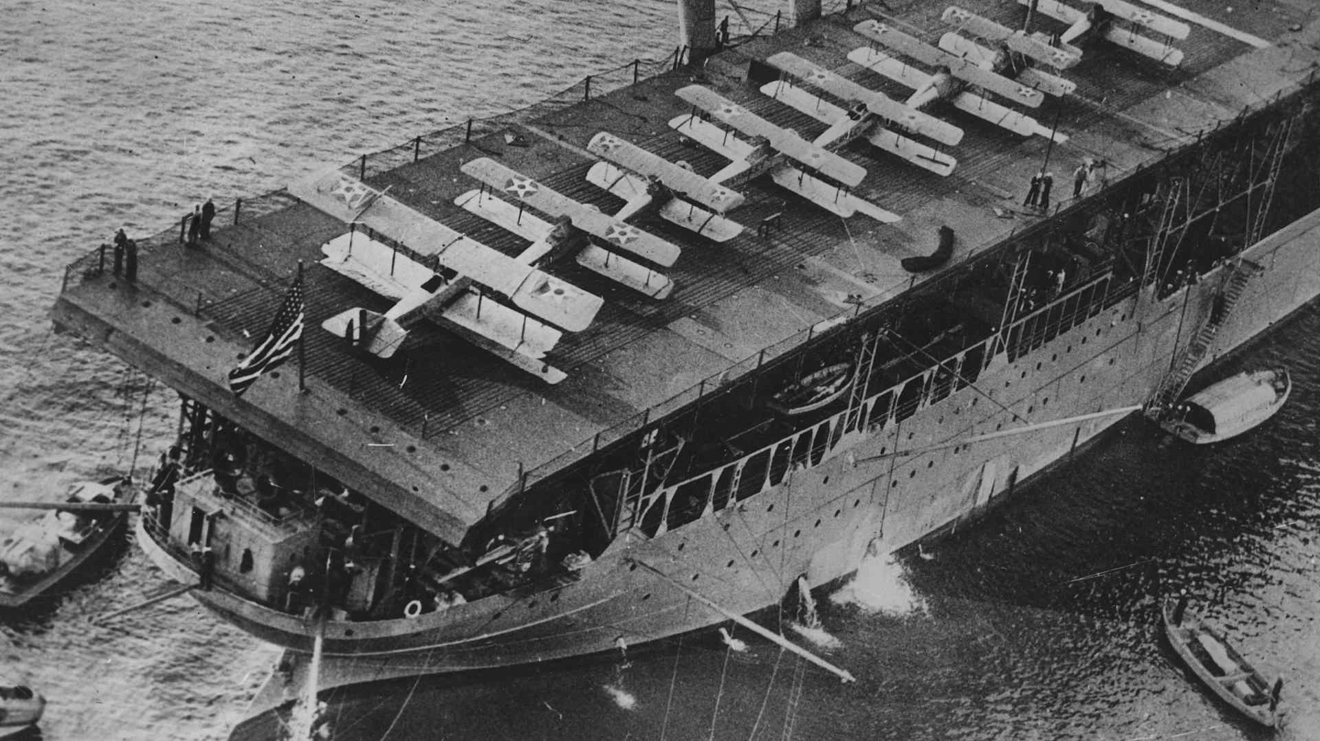 The US Navy's first aircraft carrier, the USS Langley, with eight warplanes on deck, during a show of naval strength off Baltimore.