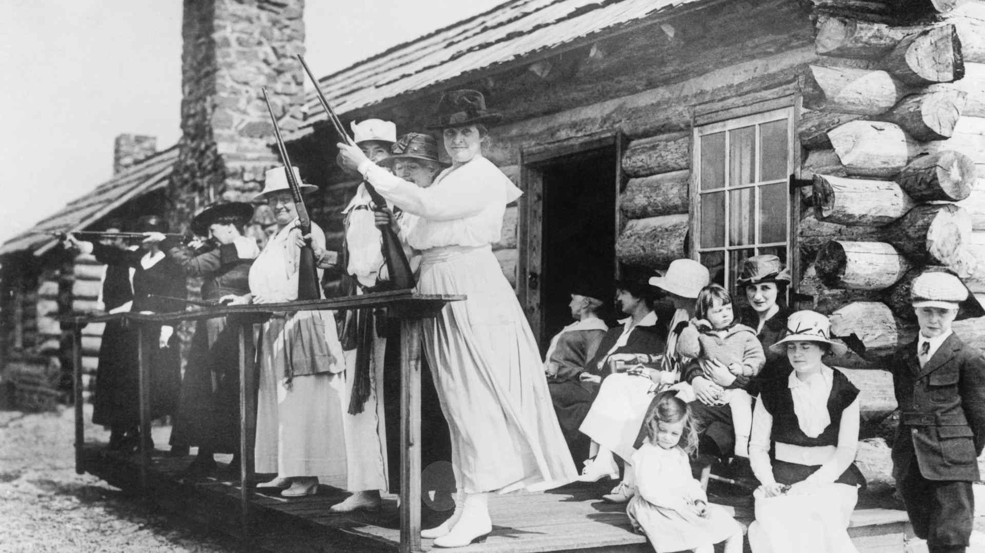 Annie Oakley teaching women to shoot rifles