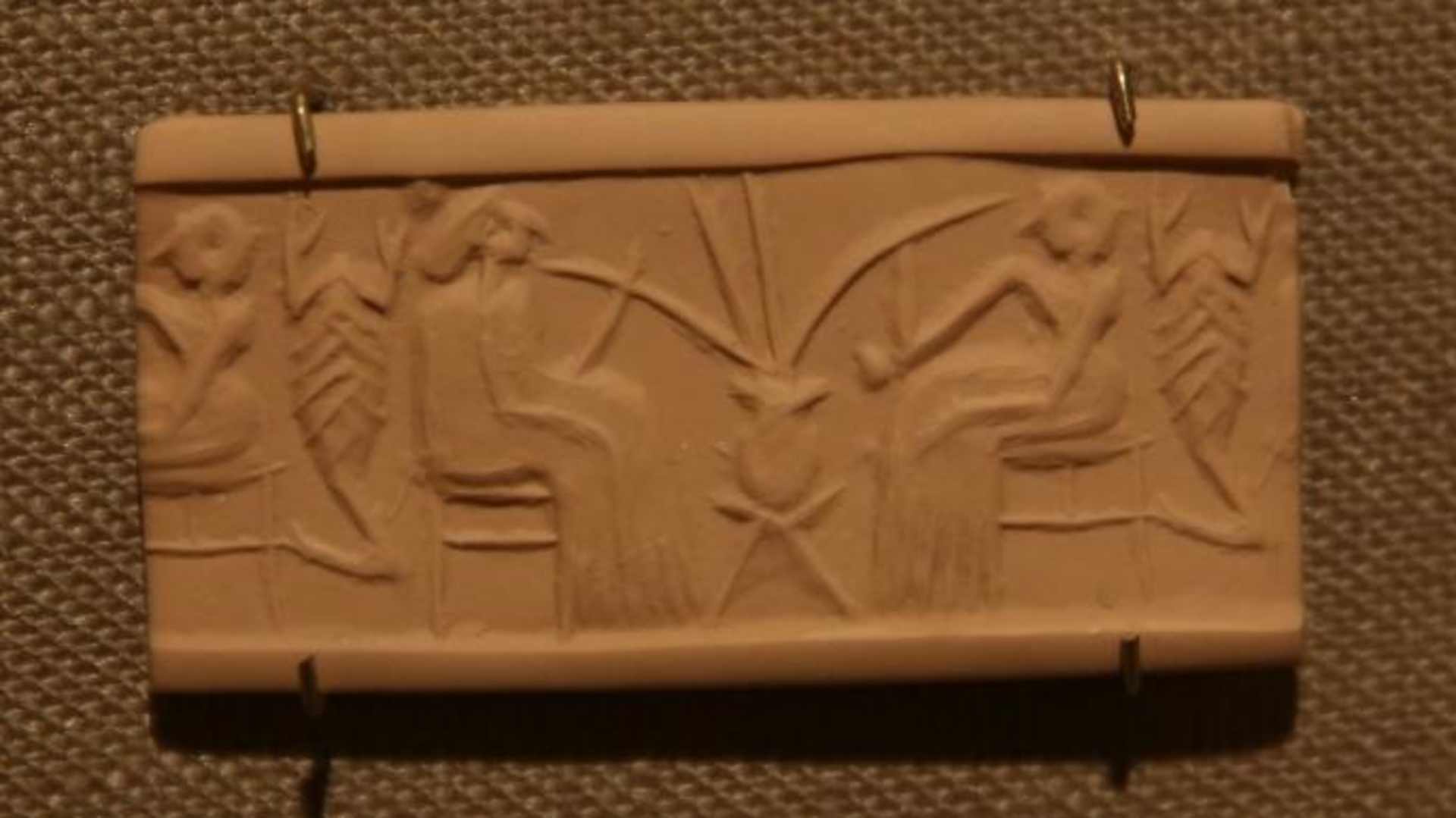 A clay seal depicting beer drinking in a banquet scene dating from 2600-2350 B.C.