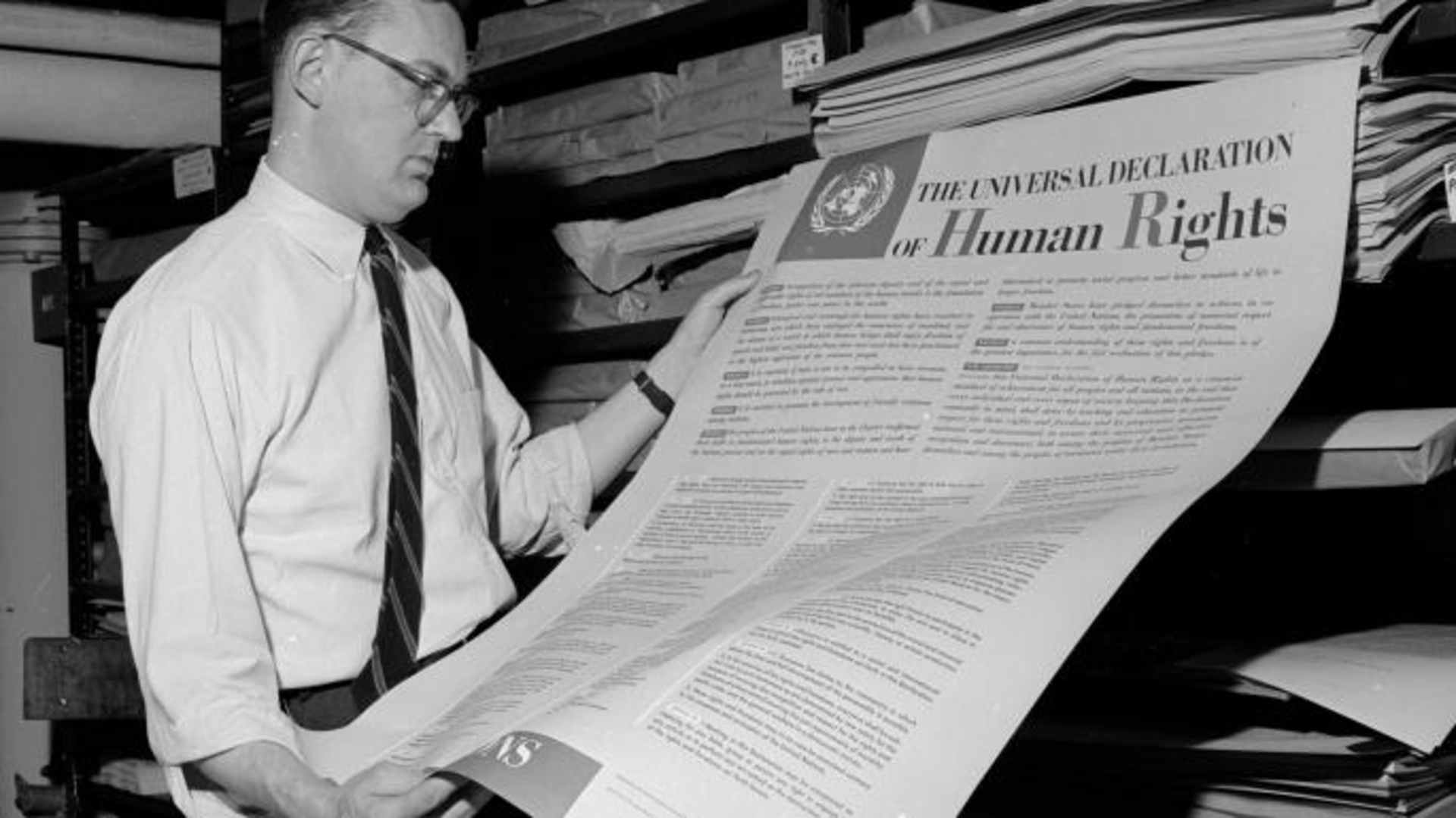 A man looks at one of the first documents published by the United Nations, The Universal Declaration of Human Rights.  (Credit: Three Lions/Getty Images)