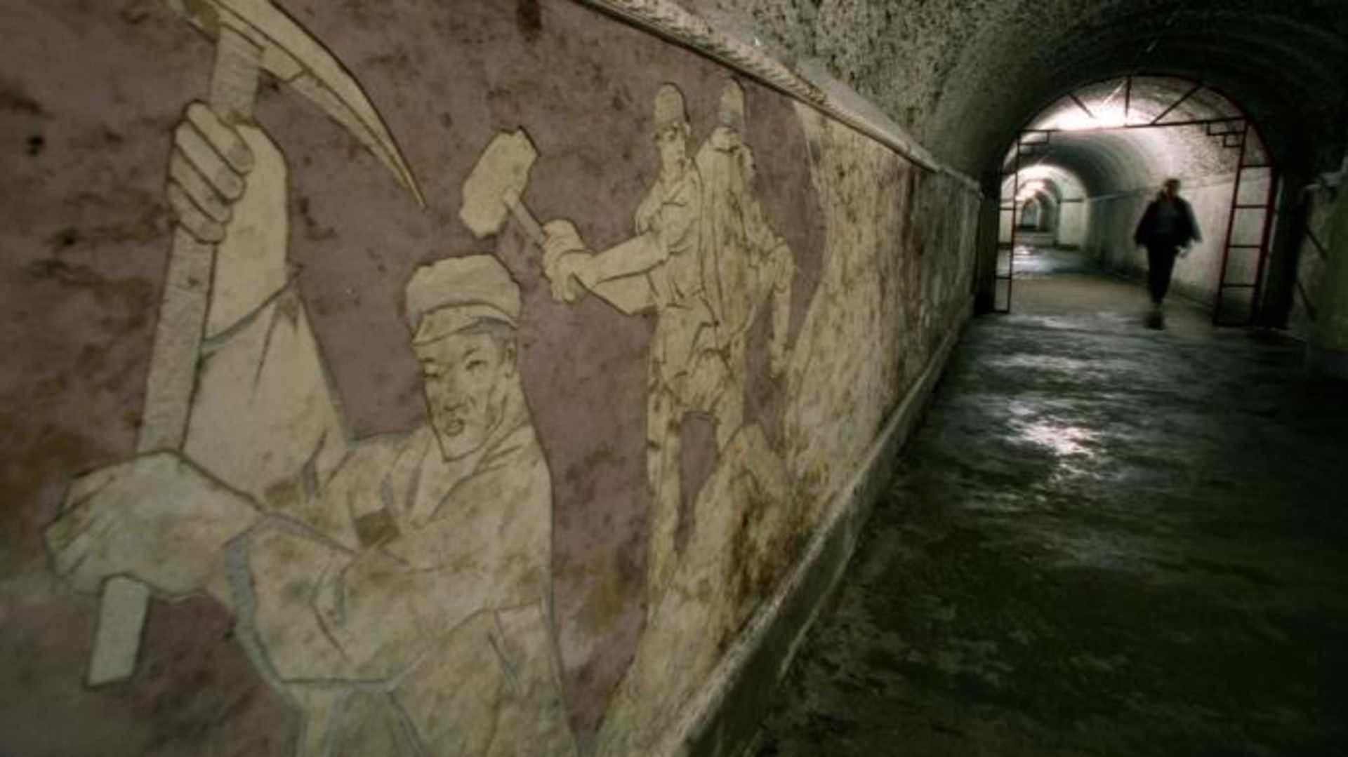 A mural dedicated to the workers who dug the tunnels that later became the Beijing Underground City in Beijing, China. (Credit: Bryan Chan/Los Angeles Times/Getty Images)
