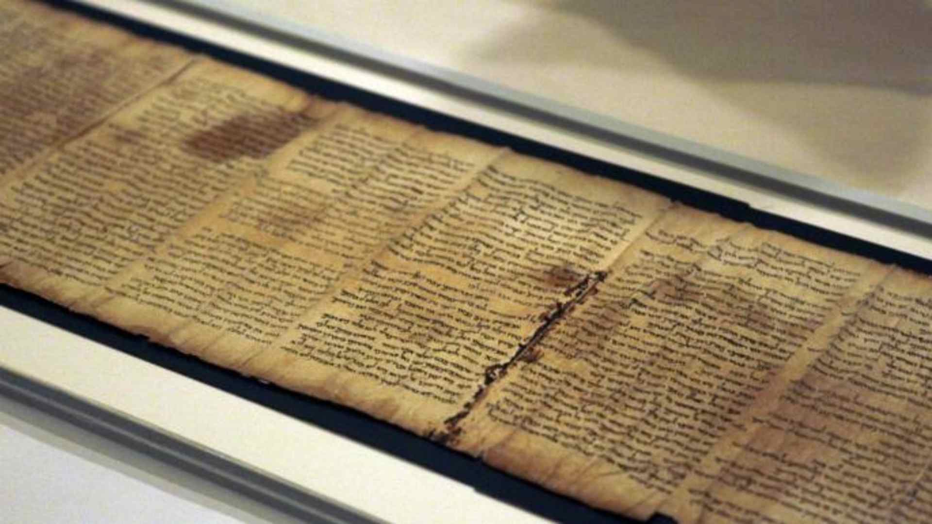 A part of the Isaiah Scroll, one of the Dead Sea Scrolls, is seen inside the vault of the Shrine of the Book building at the Israel Museum. (Credit: Lior Mizrahi/Getty Images)