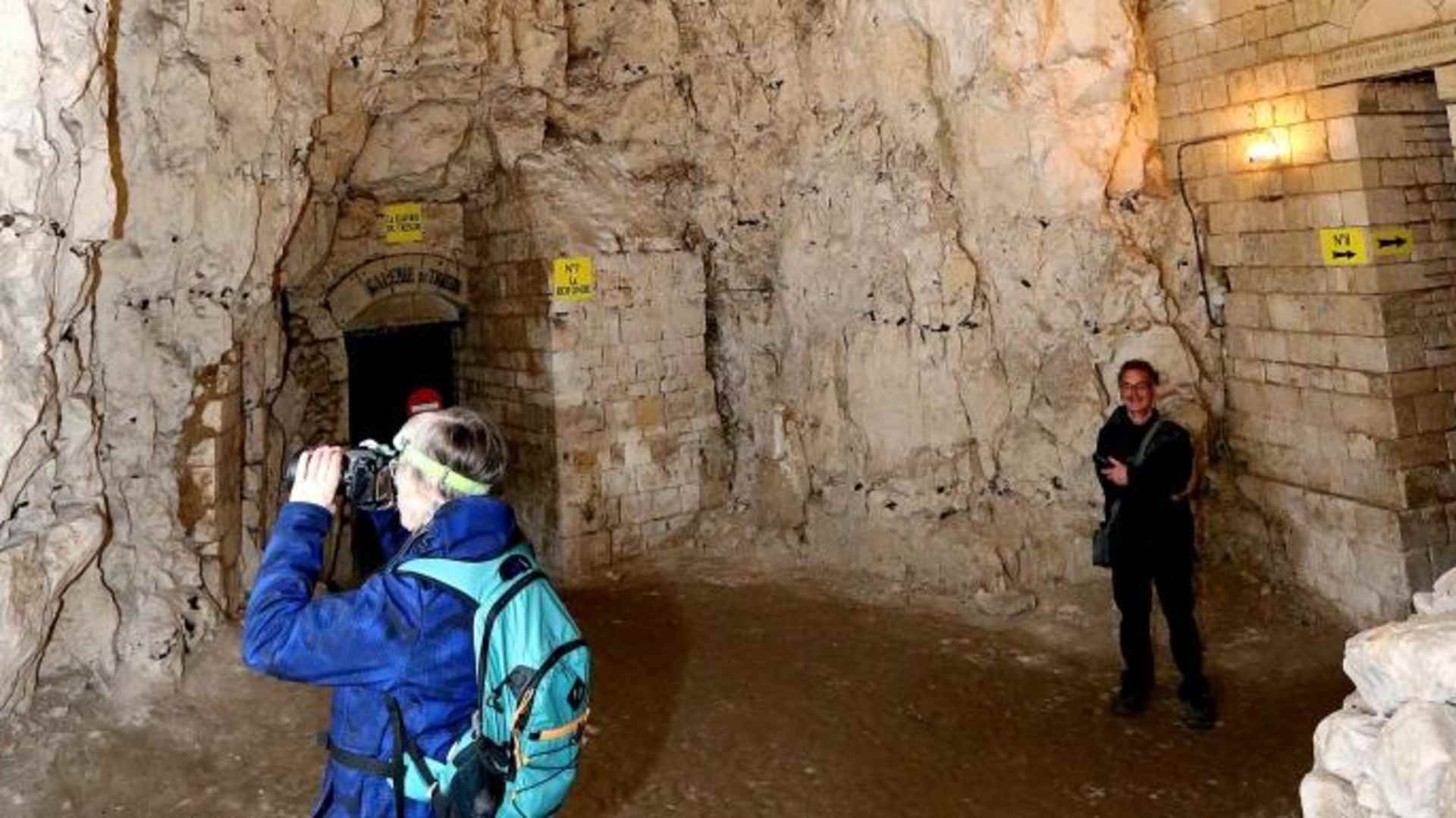 A tourist takes a picture inside the Naours underground city. (Credit: FRANCOIS NASCIMBENI/AFP/Getty Images)