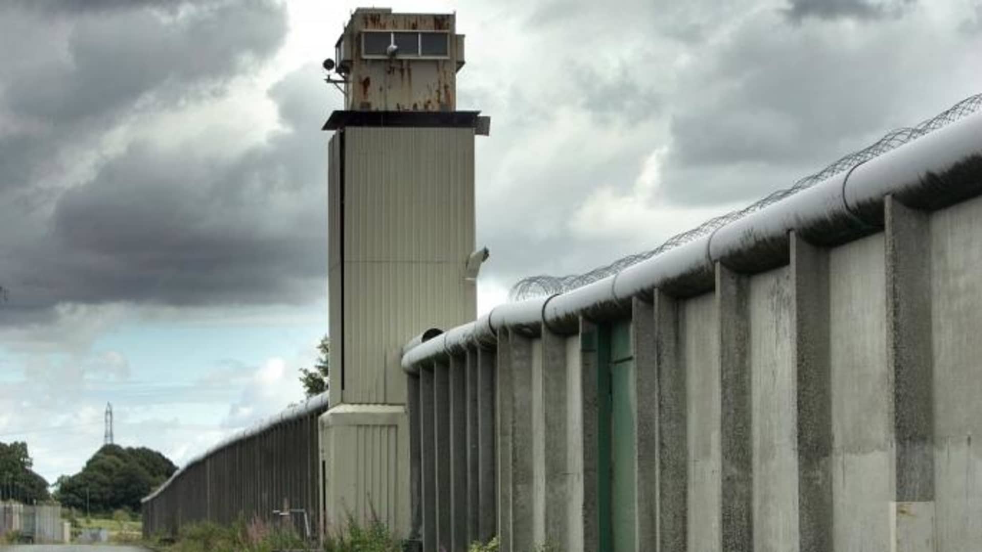 A watchtower and perimeter wall marks the boundary of the former Maze Prison, west of Belfast in Northern Ireland.  (Credit: Paul Mcerlane/Getty Images)