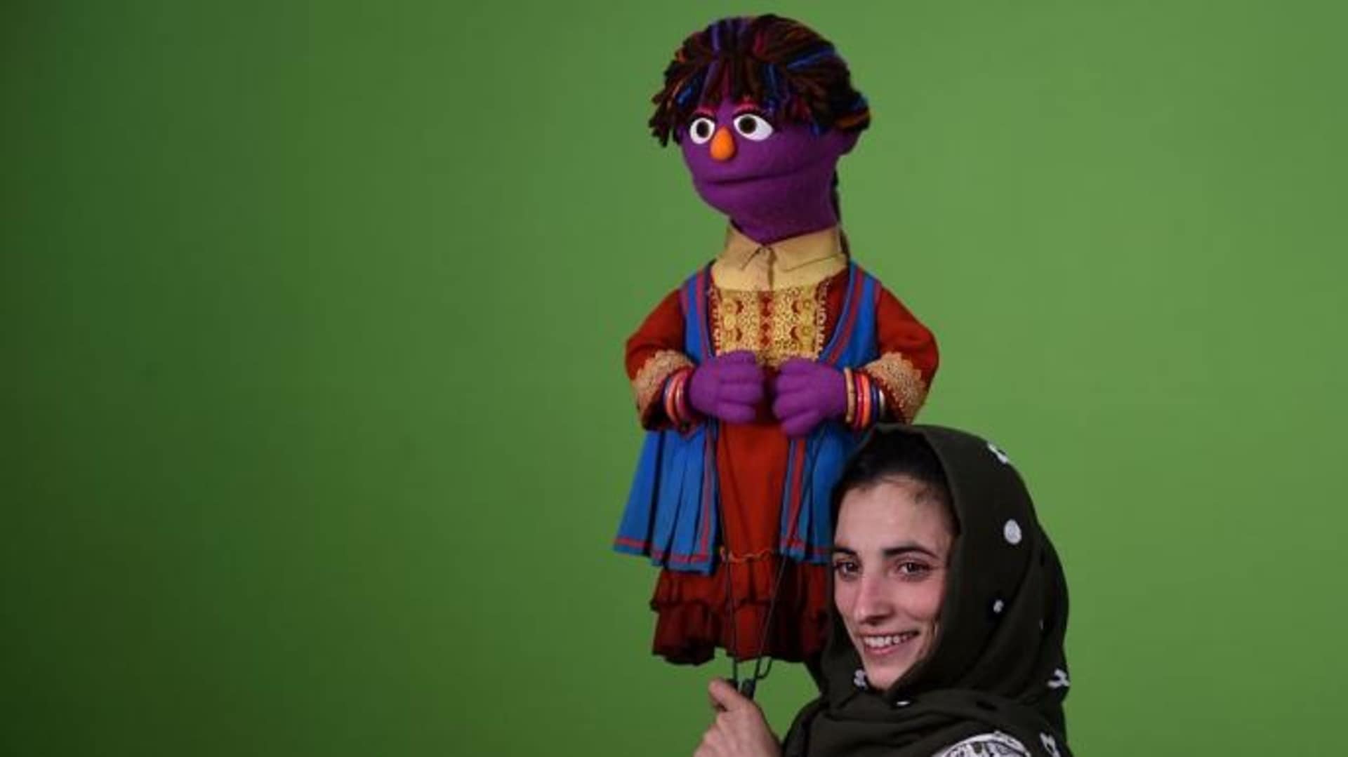 Afghan puppeteer Seema Sultani holds a muppet named "Zari" for a recording of the Afghan show "Baghch-e-Simsim", or Sesame Garden.