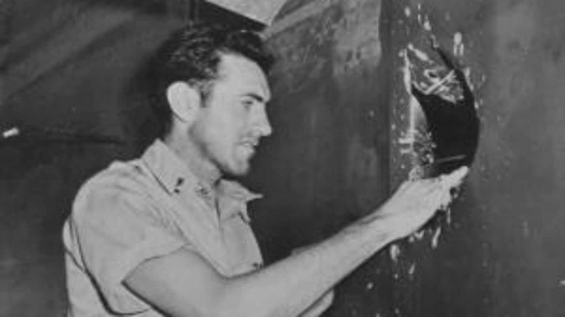 American bombadier (and former Olympic athlete) Lt Louis Zamperini (1917 - 2014) examines damage in the fuselage of his B-24 Liberator, Funafuti, Ellice Island (later known as Tuvalu), May 1943. The hole was caused by a cannon shell from an Japanese Zero, which also scored three other hits, before Zamperini's plane managed to fly back from Nauru . (Photo by PhotoQuest/Getty Images)