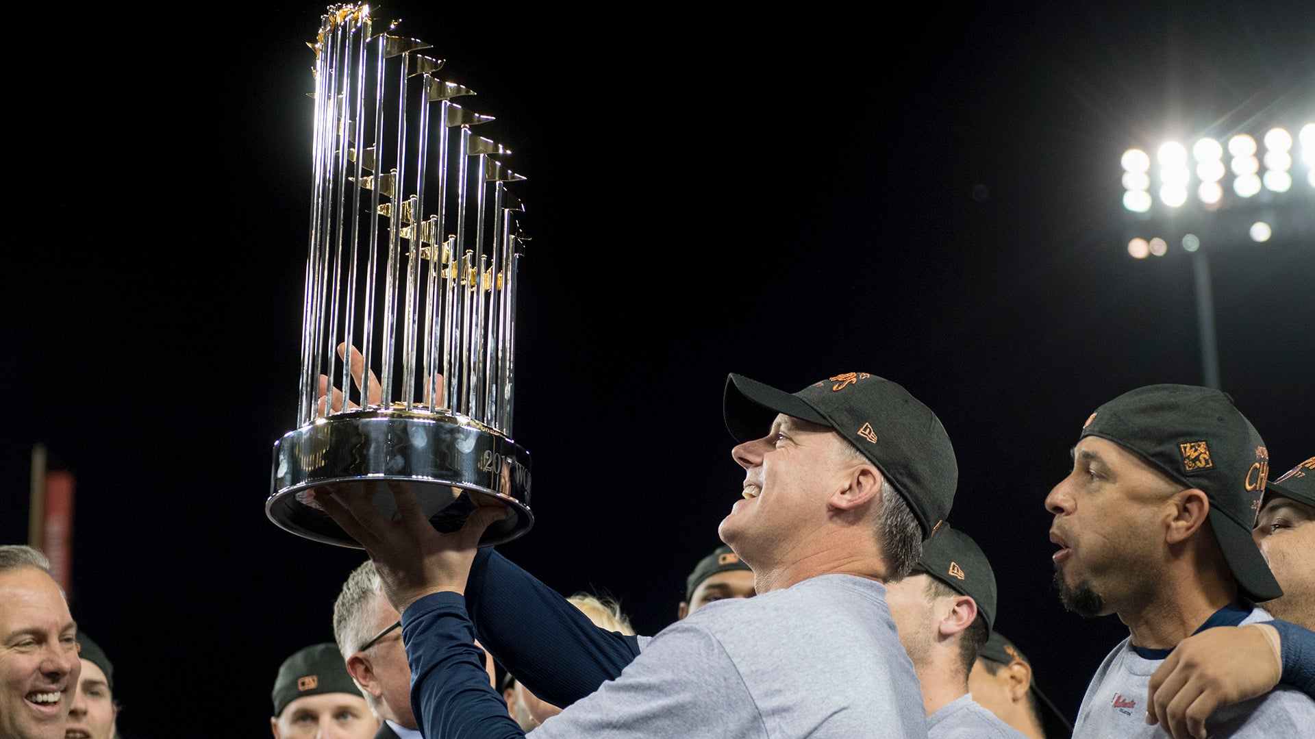 Houston Astros manager A.J. Hinch holds up the World Series trophy after his team's 2017 World Series win. The team was later accused of cheating.