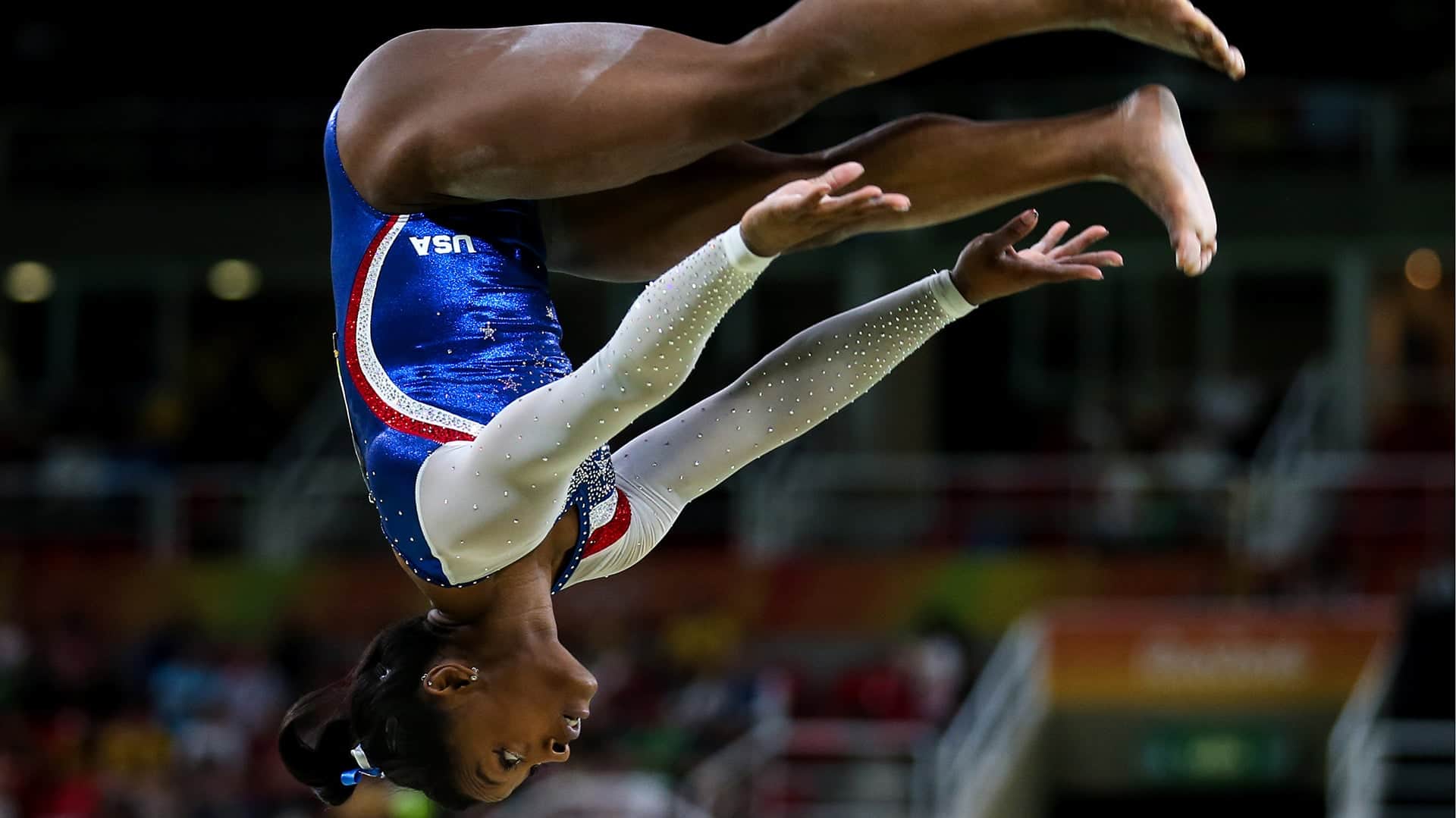 RIO DE JANEIRO, BRAZIL - AUGUST 11, 2016: Simone Biles of the USA performs her routine during the artistic gymnastics women's individual all-around final event at the 2016 Summer Olympic Games in Rio de Janeiro, Brazil, at Rio Olympic Arena.