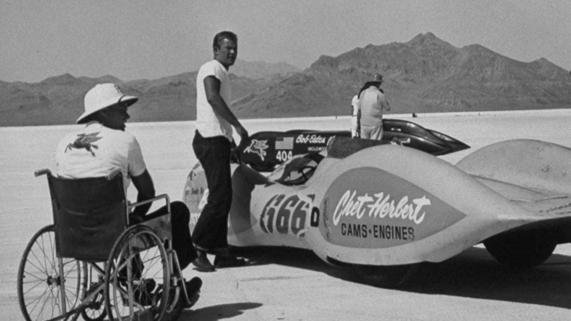 Chet Herbert supervising from his wheelchair before a race. Herbert designed the roller camshaft for competition engines.