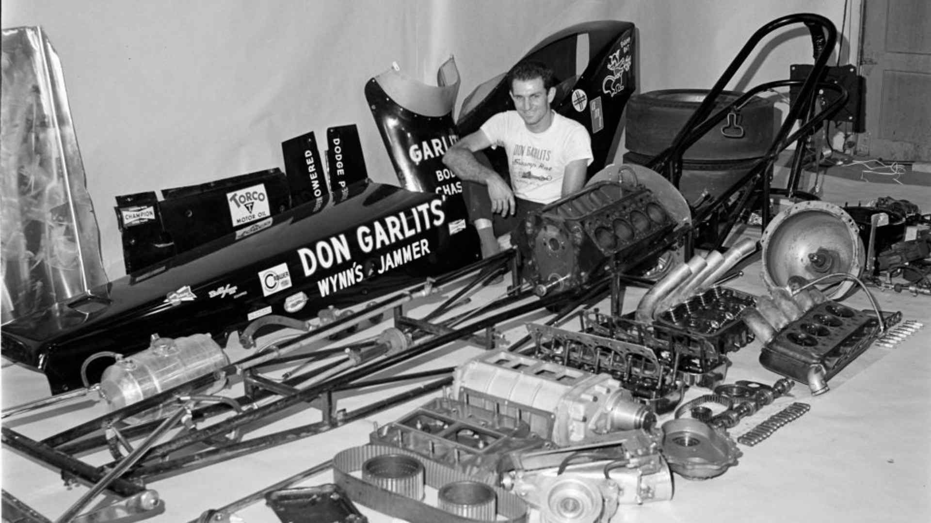 Don Garlits sitting among the numerous parts that make up his winning dragsters.