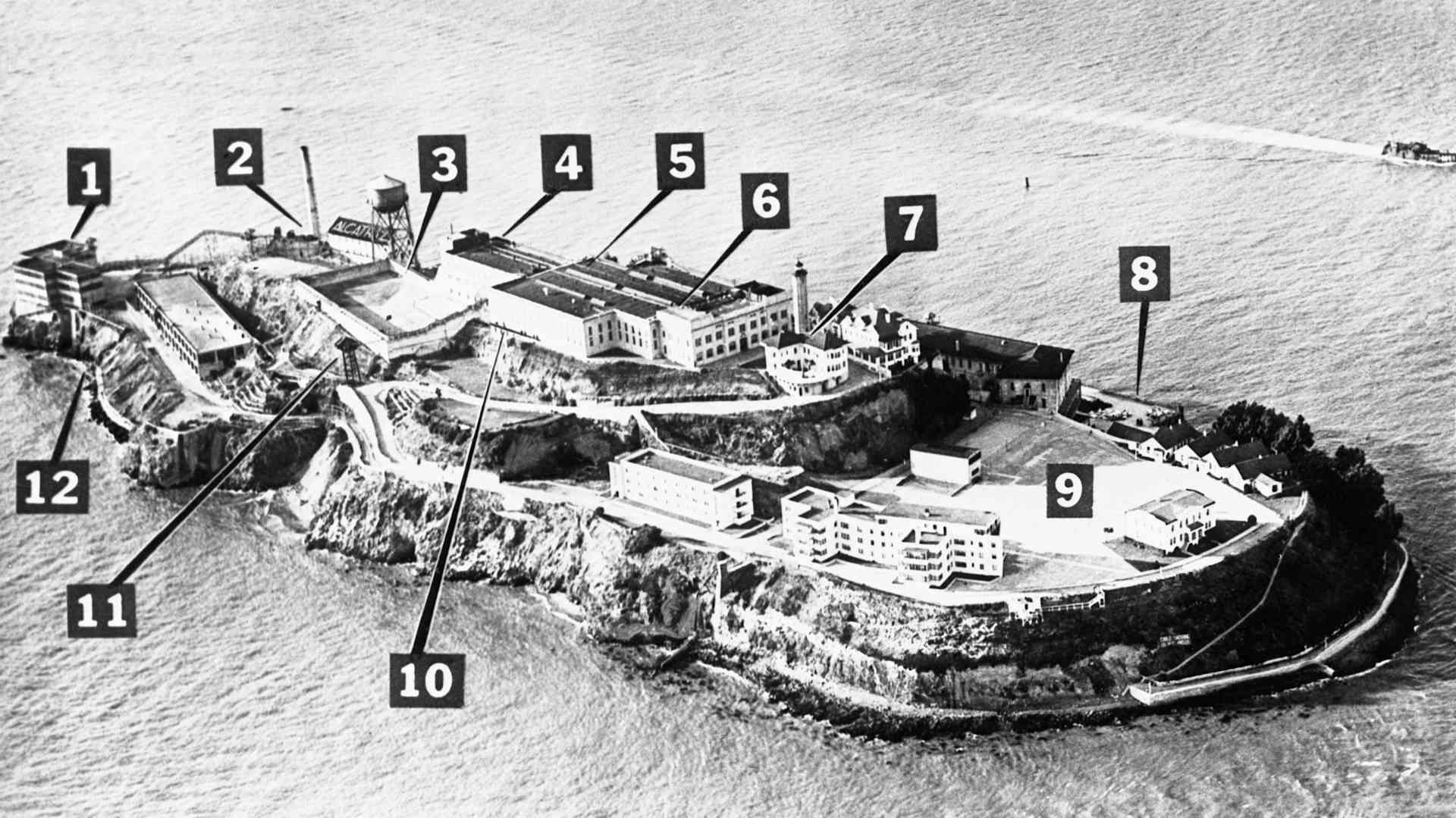 Photo diagram of the Battle of Alcatraz that took place at Alcatraz Federal Penitentiary from May 2nd-4th, 1946. This aerial photo of the island identify the principal buildings and location of violence during the incident: 1. shoe and furniture shop; 2. power house; 3. prisoner's yard; 4. men's hall and kitchen; 5. main cell block; 6. administration and warden's office; 7. warden's home; 8. landing dock; 9. guard's recreation yard; 10. catwalk; 11. guard tower; 12. wharf. Guards hurled tear gas bombs into cell block (5) from catwalk (10). Non rioting convicts had gathered in yard (3) to the left of where the main battle raged.