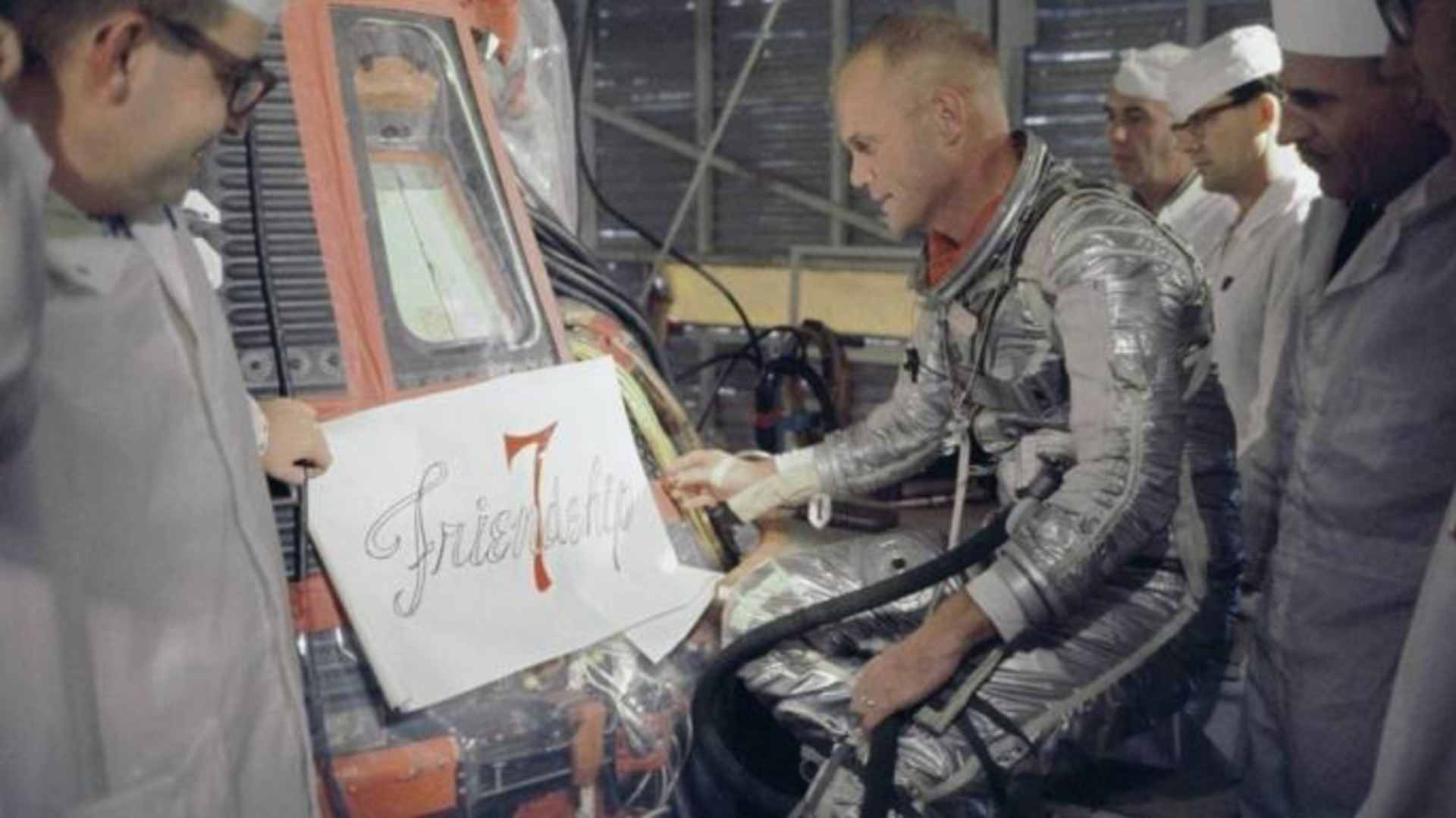 Glenn inspecting the artwork design for "Friendship 7." (Credit: NASA)