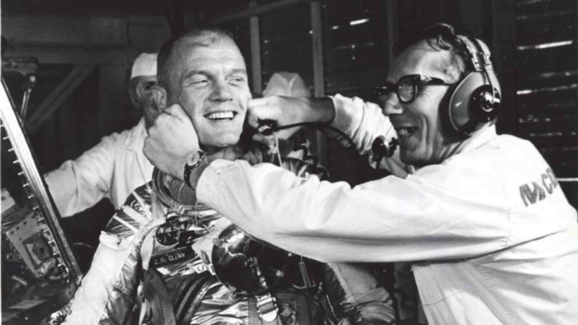 Guenter Wendt, the original pad leader for NASA's manned programs, coaxes a smile from Glenn after a postponement of the mission. (Credit: NASA)