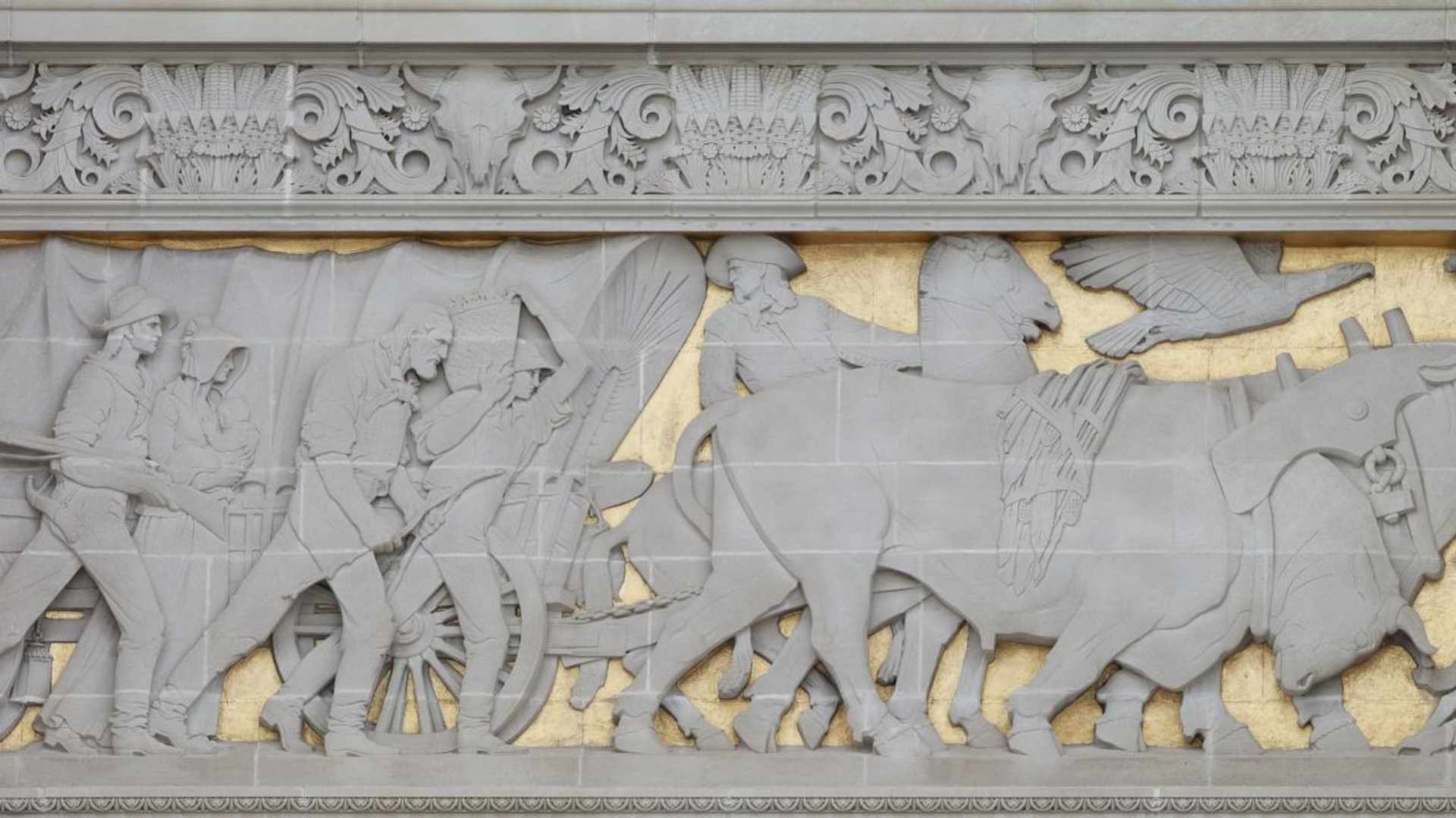 Bas-relief sculpture depicting a historical scene on the exterior of the Capitol building in Lincoln, Nebraska.