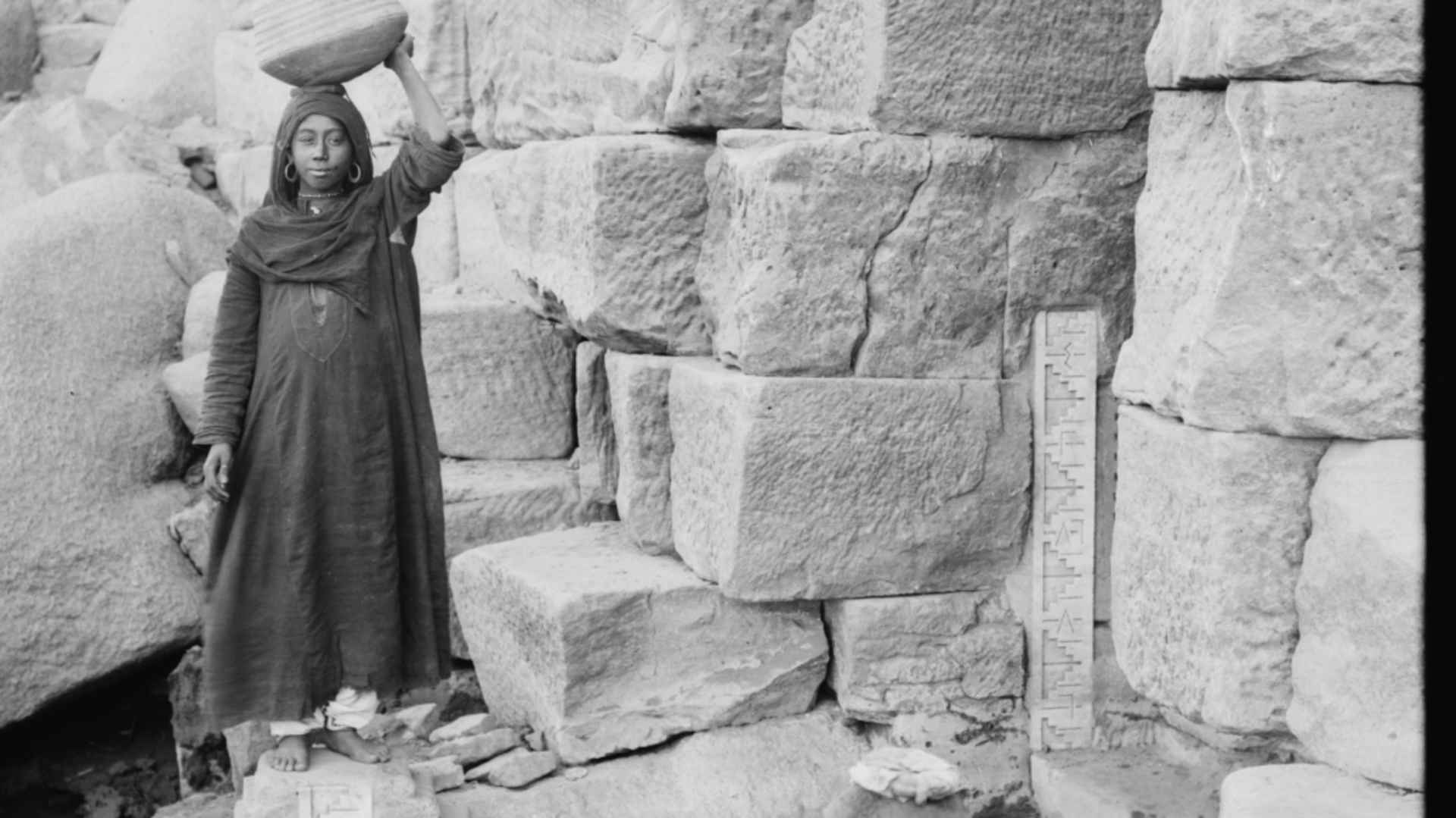 Woman in front of the Nilometer on Elephantine Island. 