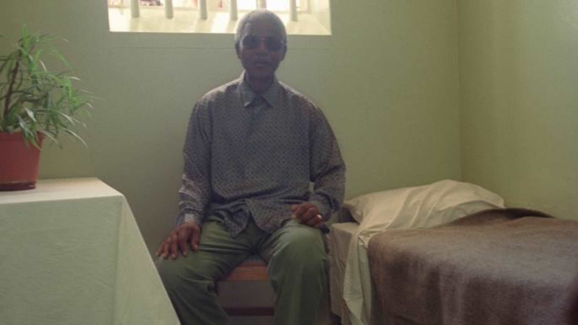 Nelson Mandela visits his former prison cell on Robben Island in February 1995. 