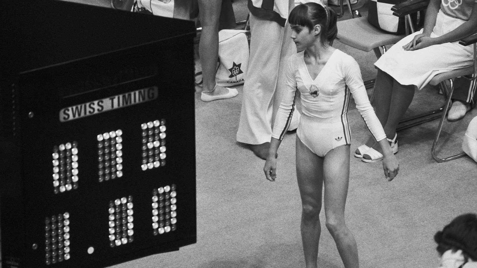 Nadia Comaneci looks at the Olympic scoreboard indicating her perfect score of 10.0, as 1.00 because the computer and the display facility were not equipped to handle what Nadia was going to do to the Olympic gymnastics competition.