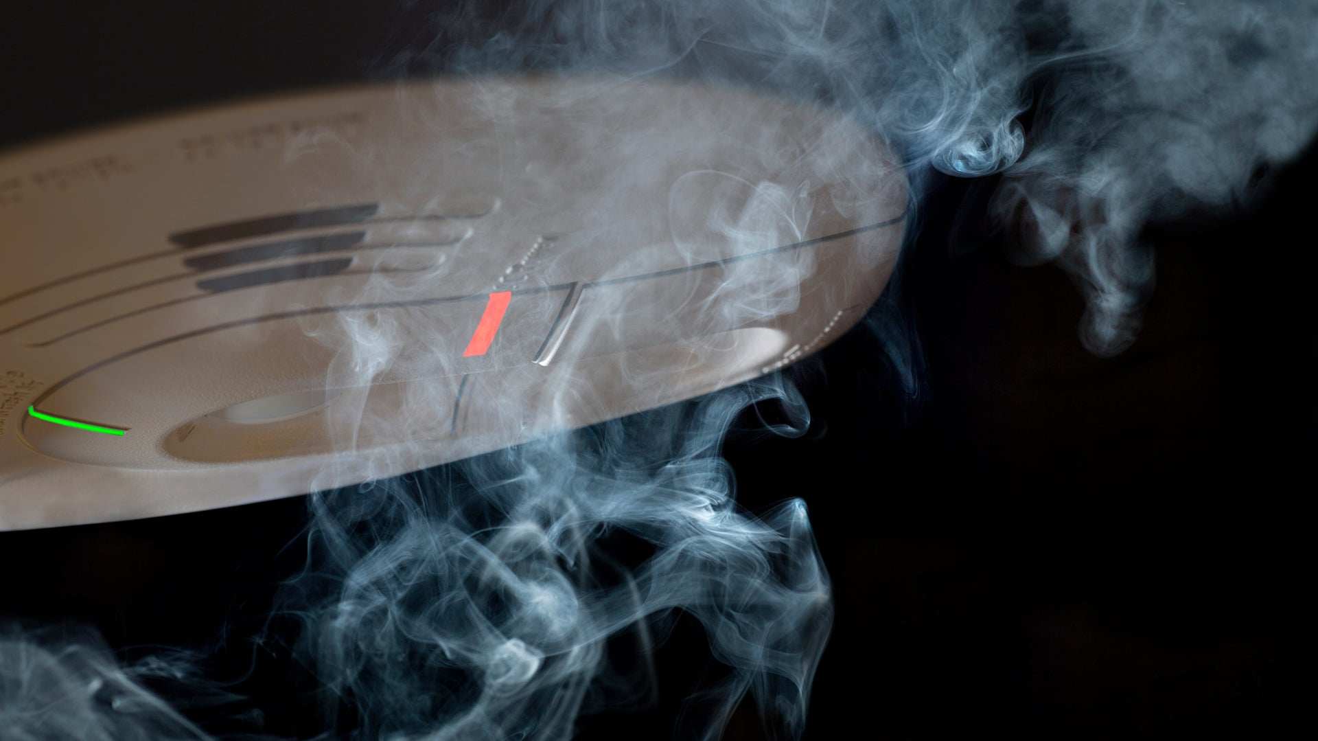 Smoke crawling over smoke detector.