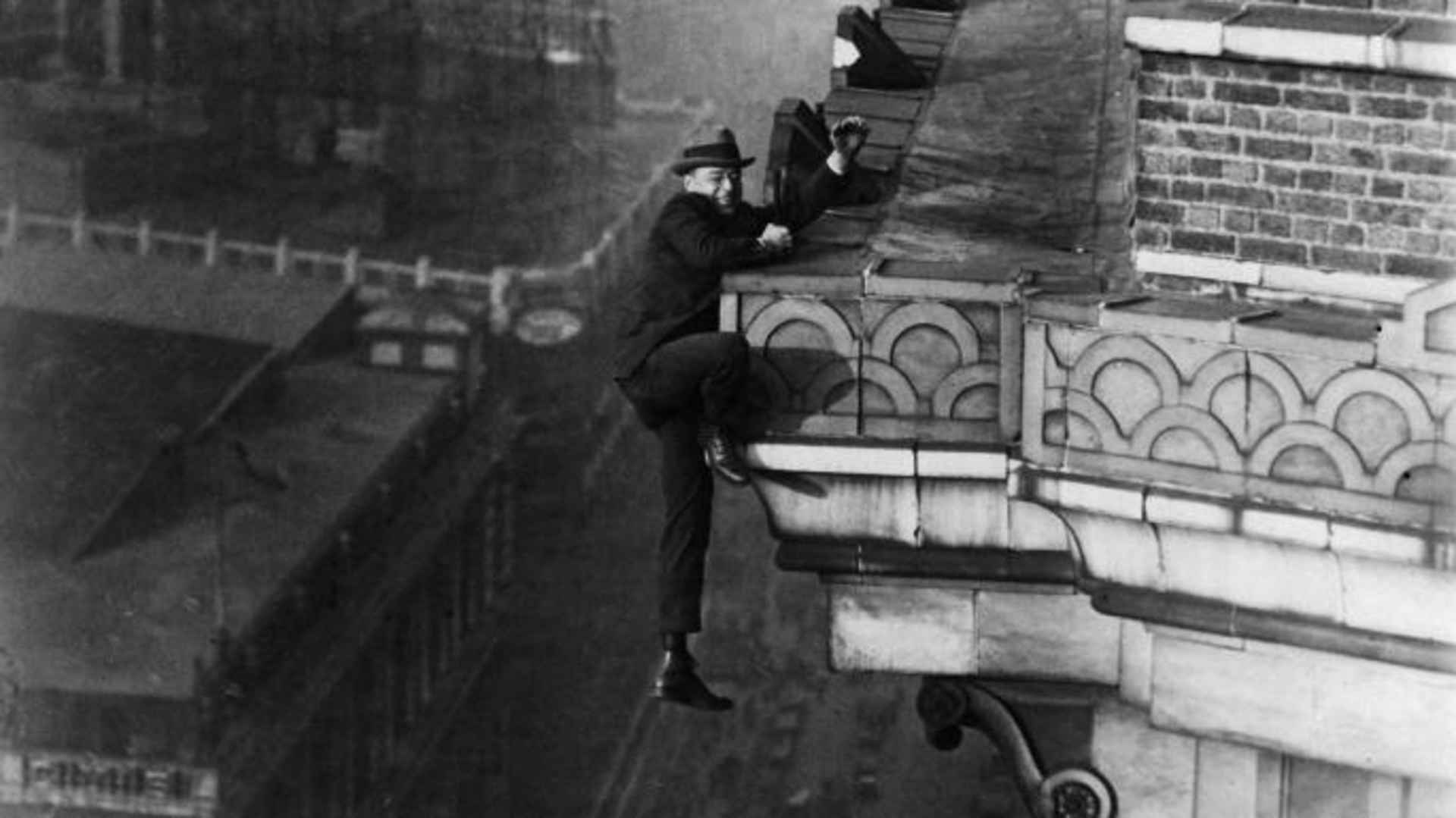 The climber, better known as the Human Fly, climbing on the front of a tower building. (Credit: Gircke/ullstein bild/Getty Images)