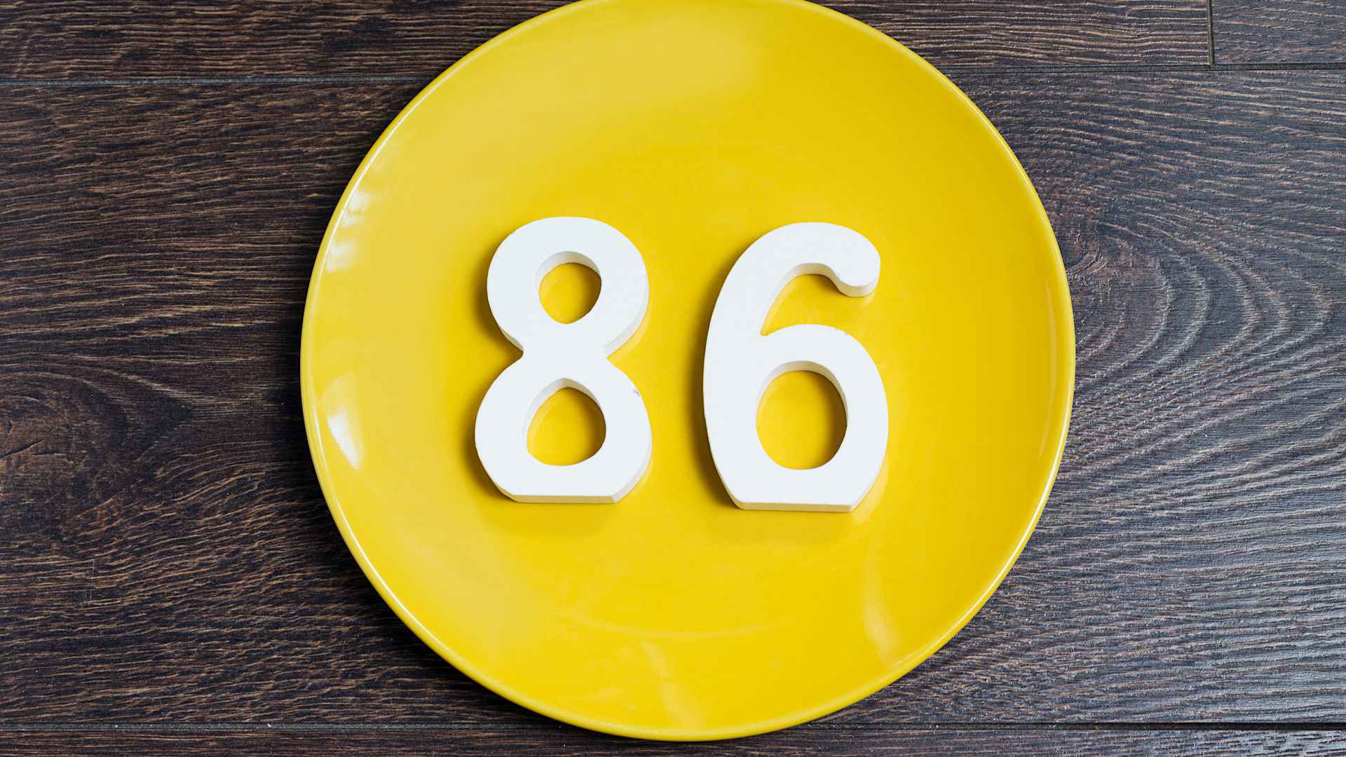 The number eighty-six on the yellow plate.