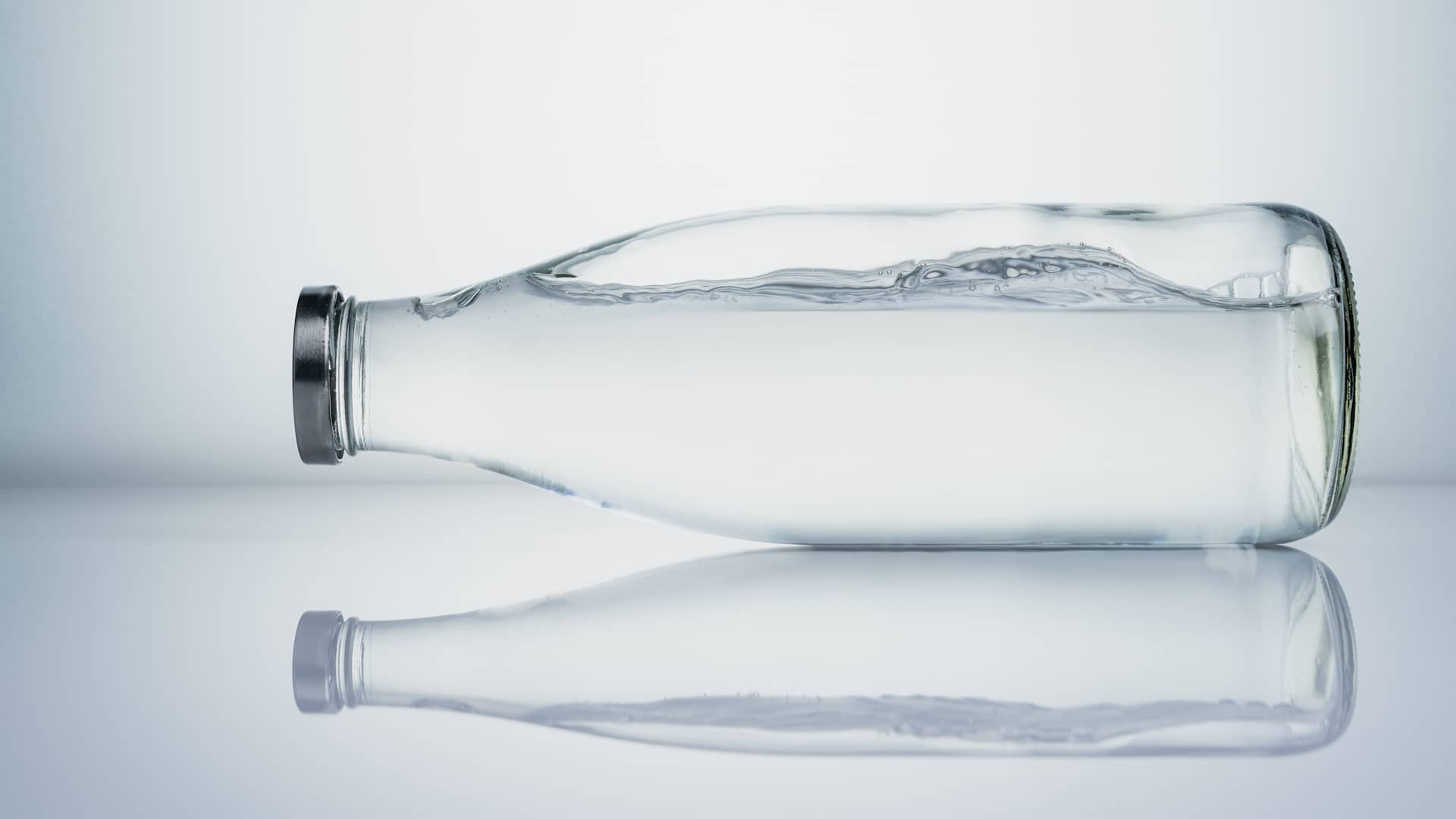 Glass bottle of water with reflection, Studio shot, Clipping path