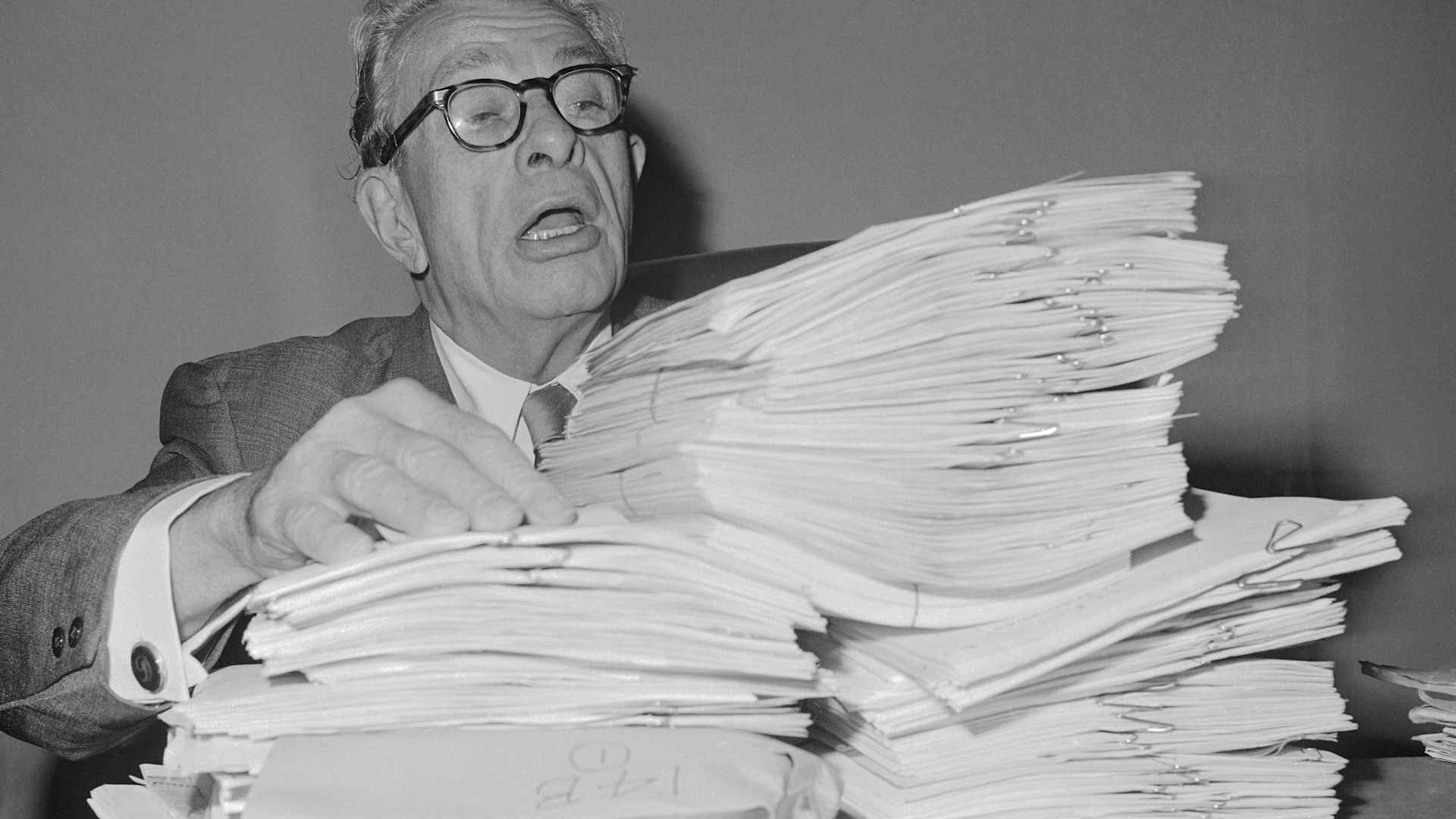 Senate GOP leader Everett M. Dirksen stacks up some of the reading material October 4, 1965, that will use in his planned filibuster against a bill to nullify state "right to work" laws.