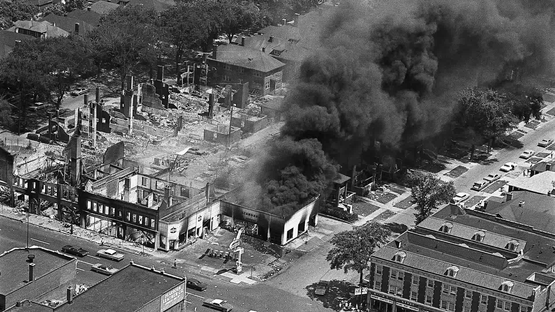 Burning Buildings in Detroit after Riots (Original Caption) 7/25/1967-Detroit: The gutted remins of buildings (left) attest to the destruction caused by two days of rioting in Detroit's west side. A service station continues to burn (right) pouring smoke and flames onto other structures. At least 23 persons have been killed and more than a thousand injured in the two days of violence.