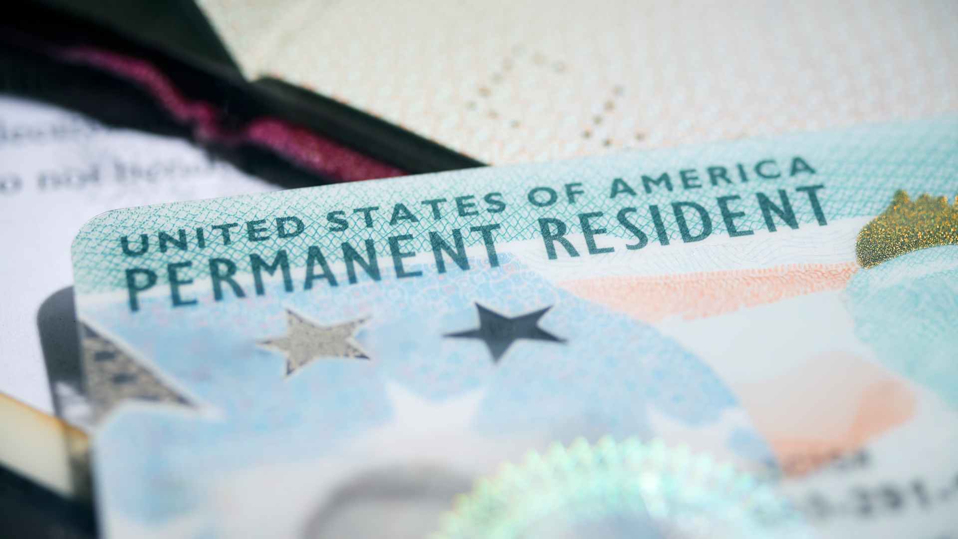 US Permanent Resident Card (Green Card) placed among various official documents