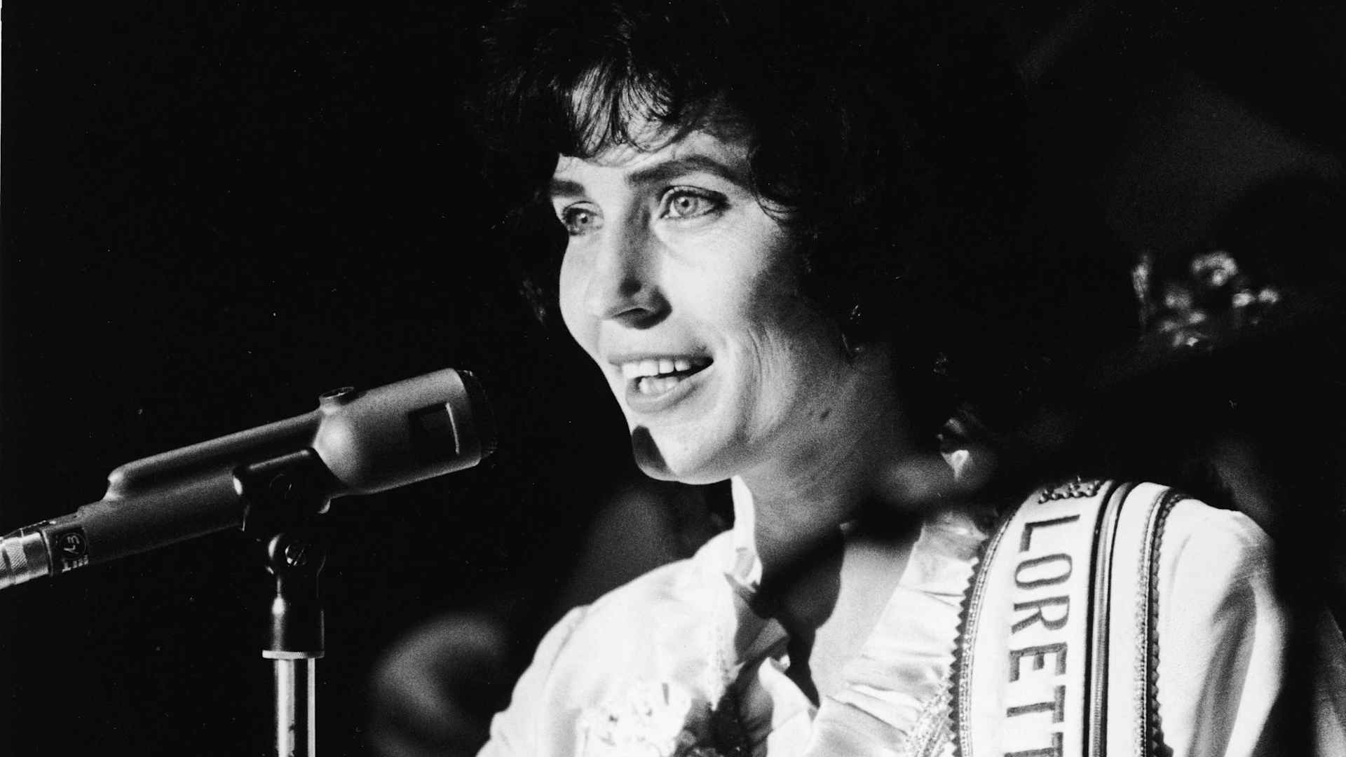 American country music singer and guitarist Loretta Lynn performs on stage at the Grand Ole Opry, 1960.