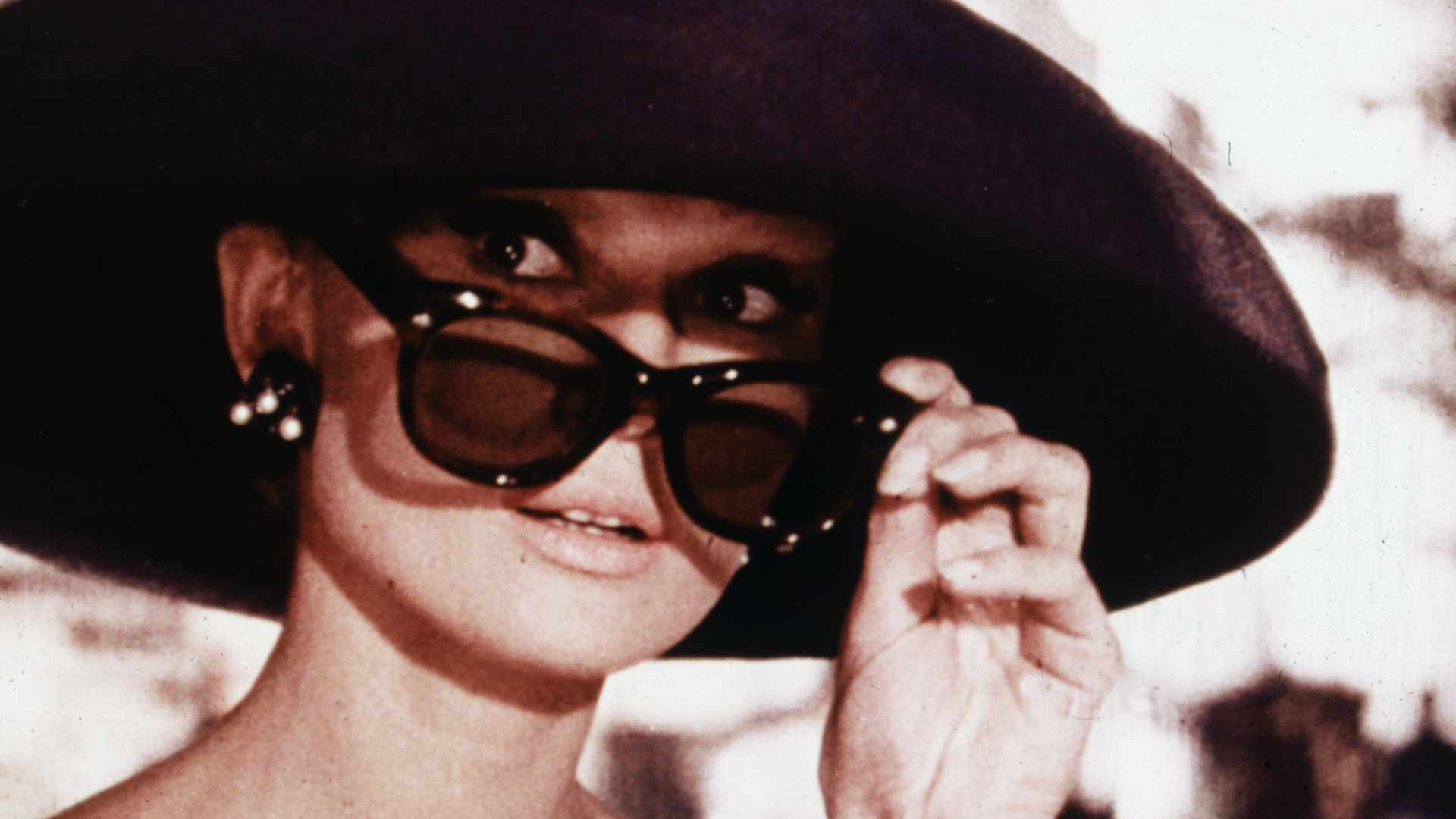 Belgian-born actress Audrey Hepburn lowers her sunglasses in a still from director Blake Edwards' film, 'Breakfast at Tiffany's.'