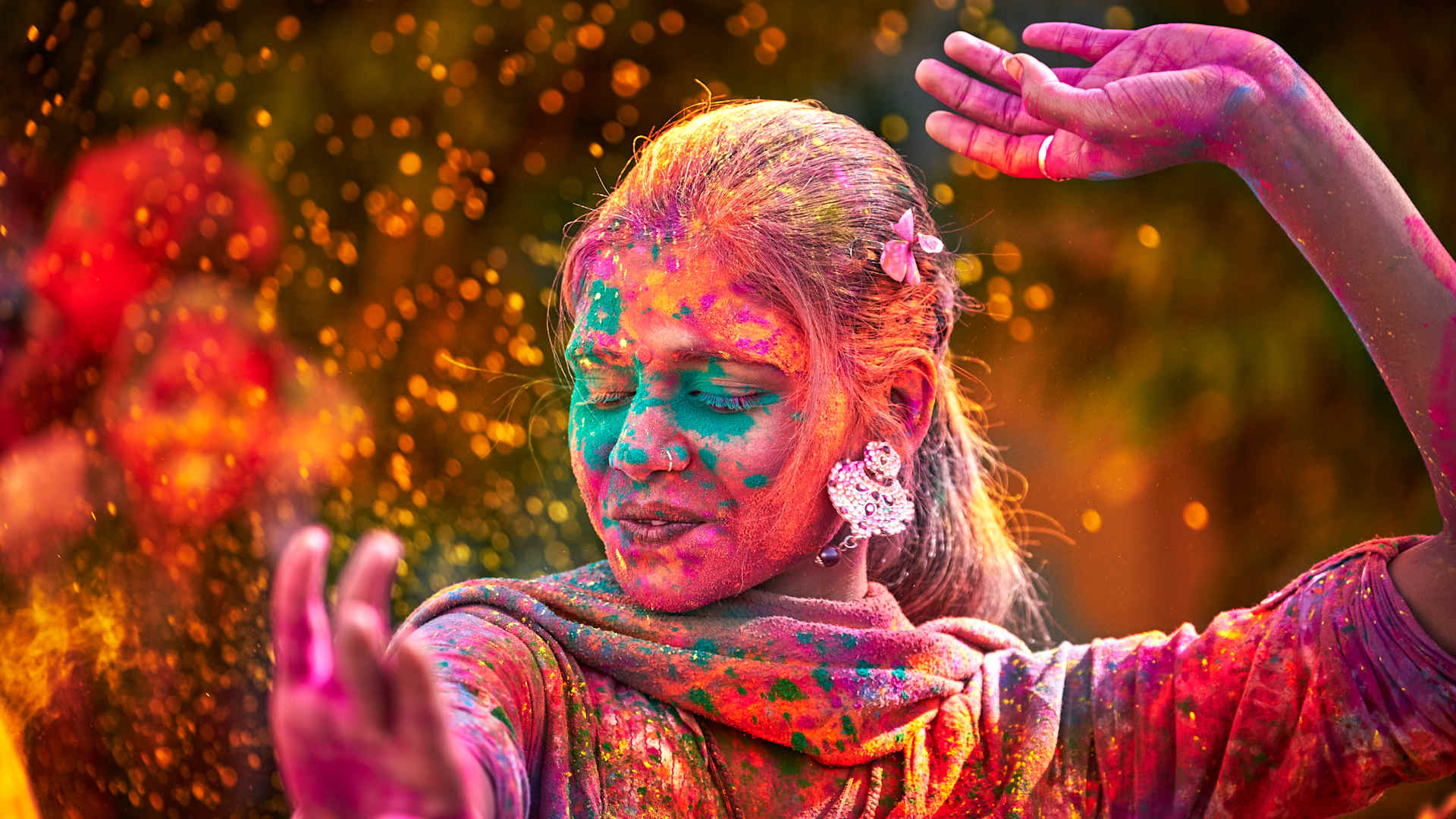 Portrait Of Indian Woman With Colored Face Dancing During Holi