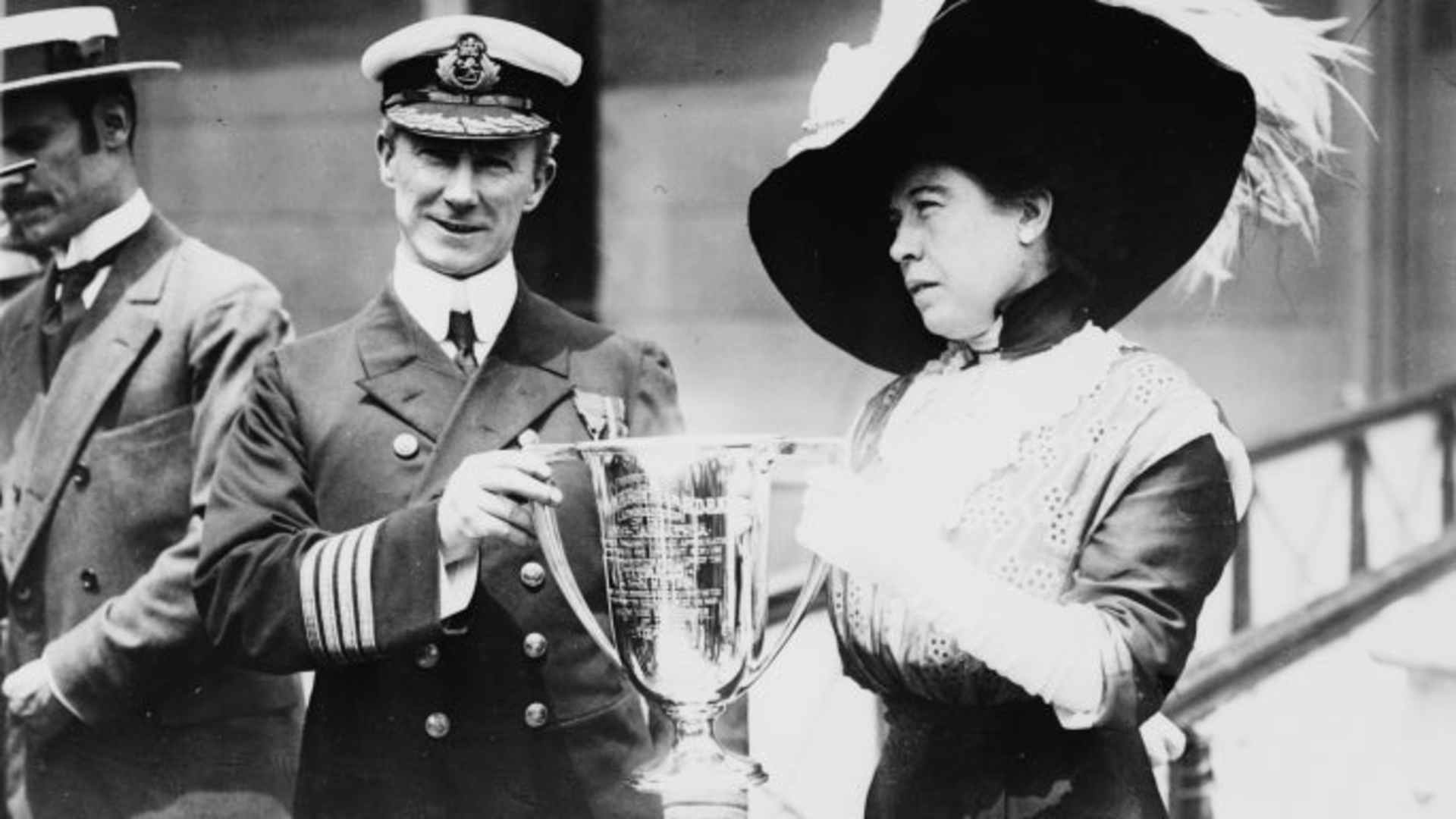 Arthur Rostron, captain of Carpathia, receives a trophy from Titanic survivor Molly Brown in May 1912.