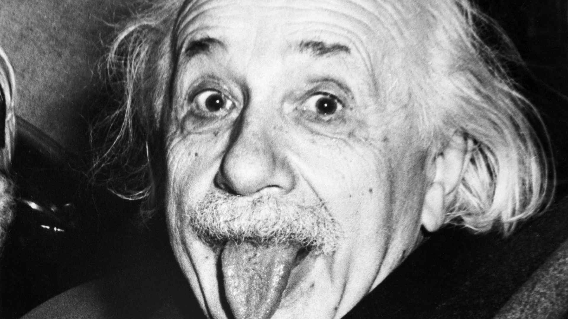 Albert Einstein sticks out his tongue.