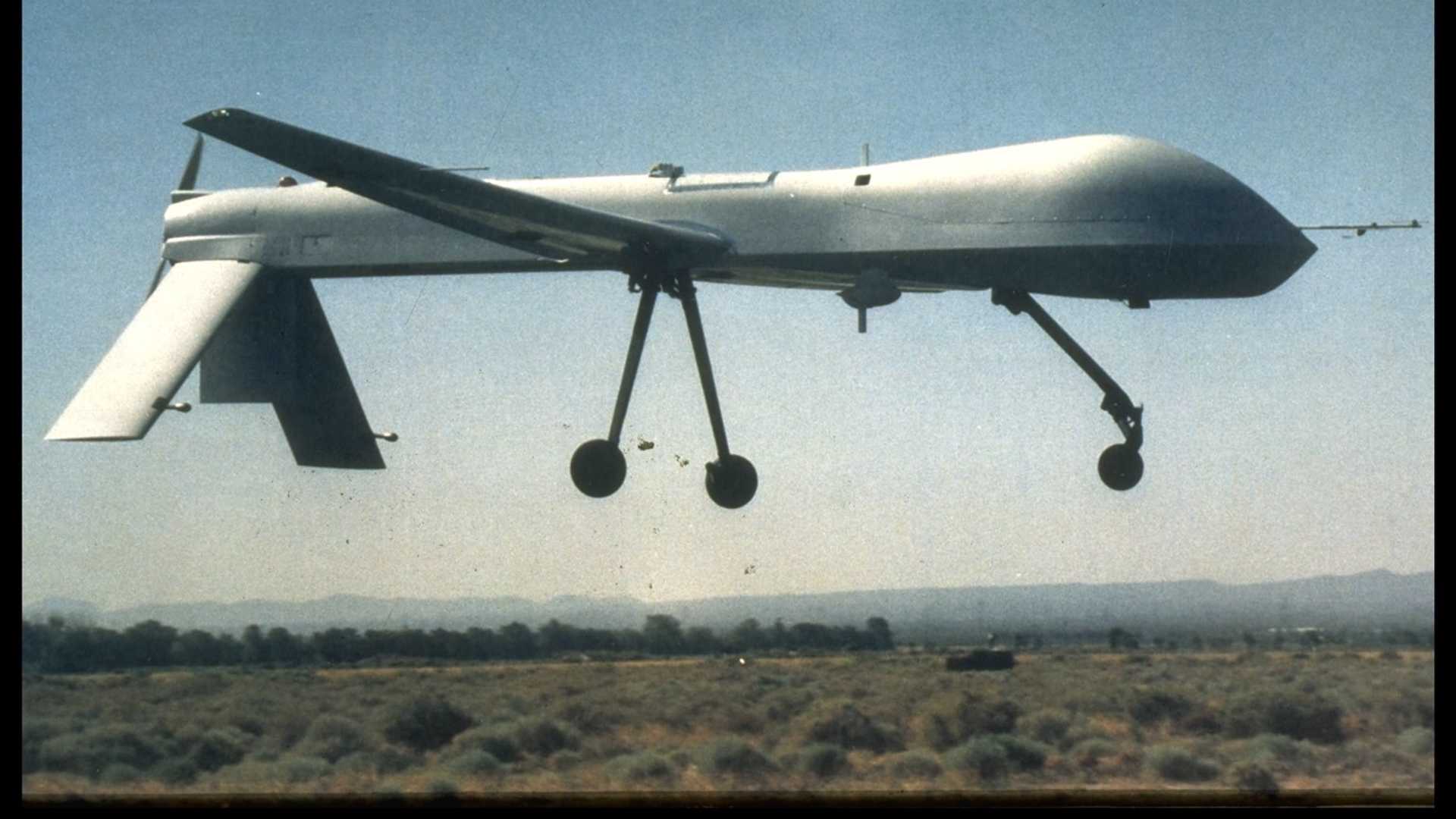 Long thin airplane with no windows, a bulbous nose and a downward-facing tail.