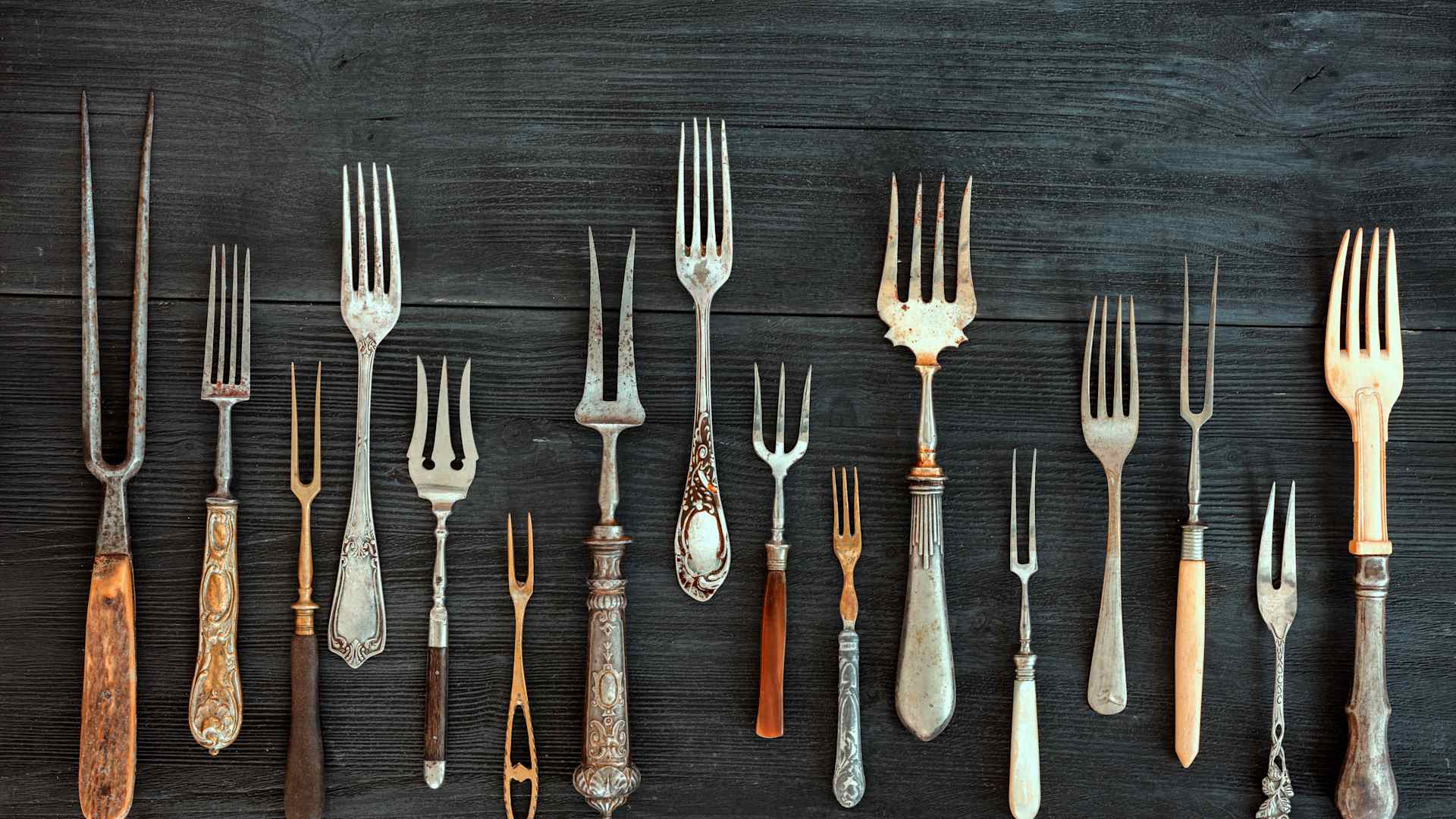 an array of antique forks