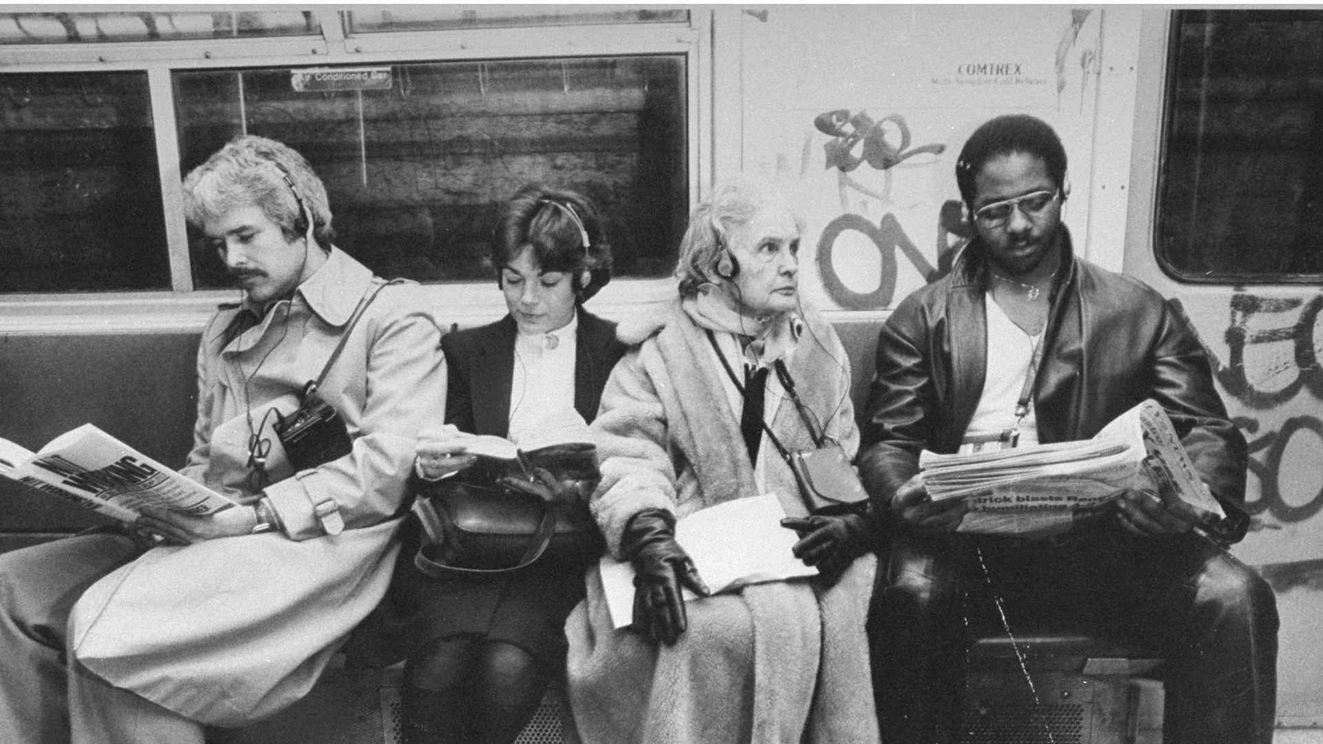 Four subway riders listening to their walkmans.
