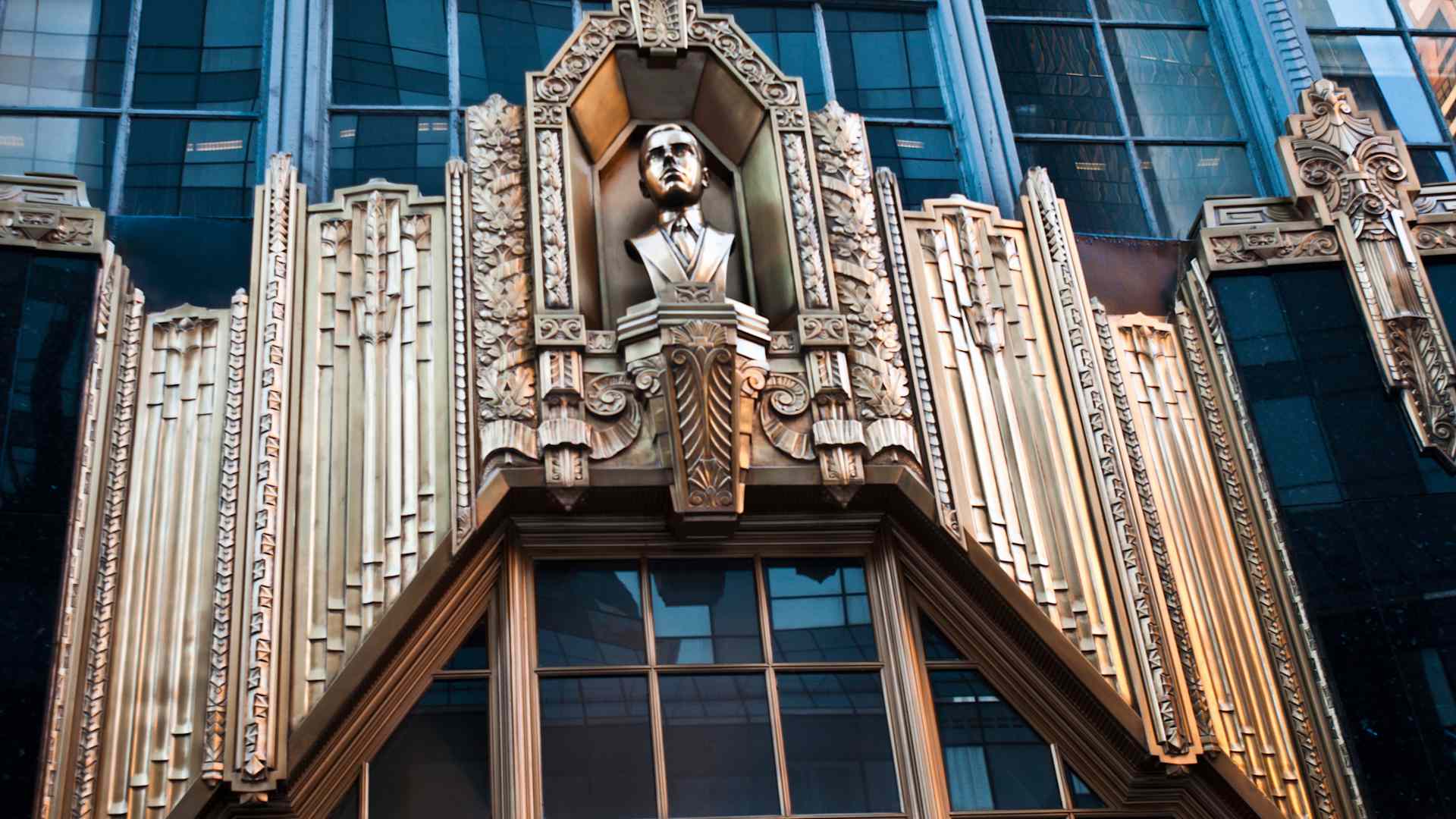 Metal bass relief with statue of Alan E. Lefcourt above entrance to Brill Building, Times Square, Manhattan, New York City, USA