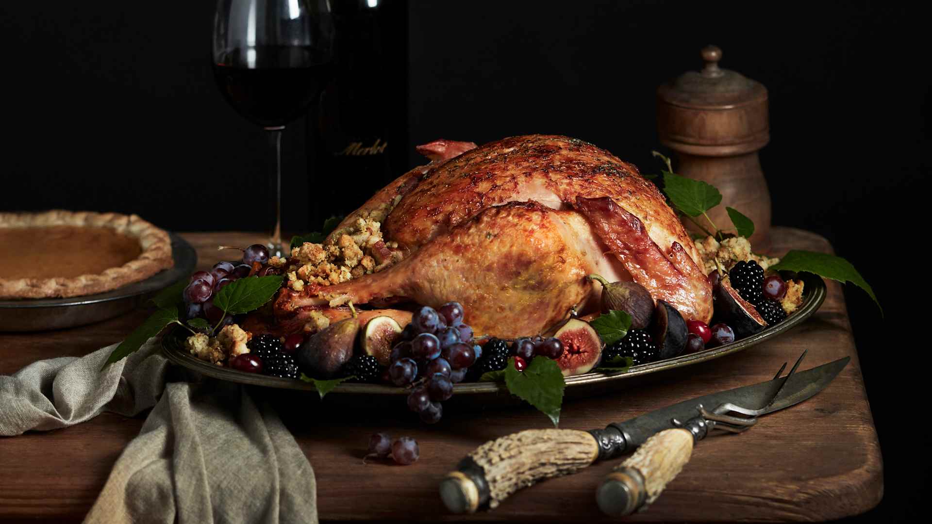 A Thanksgiving turkey on a table with pie.