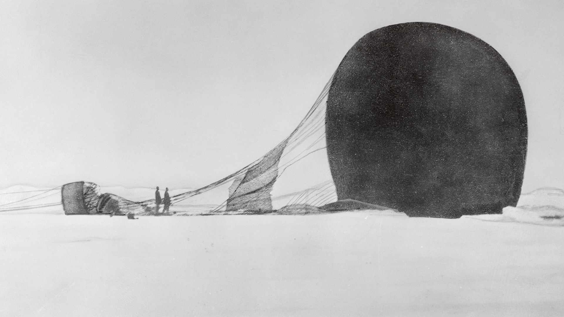 A dramatic snowy whiteout Arctic landscape with a hot air balloon lying on its side